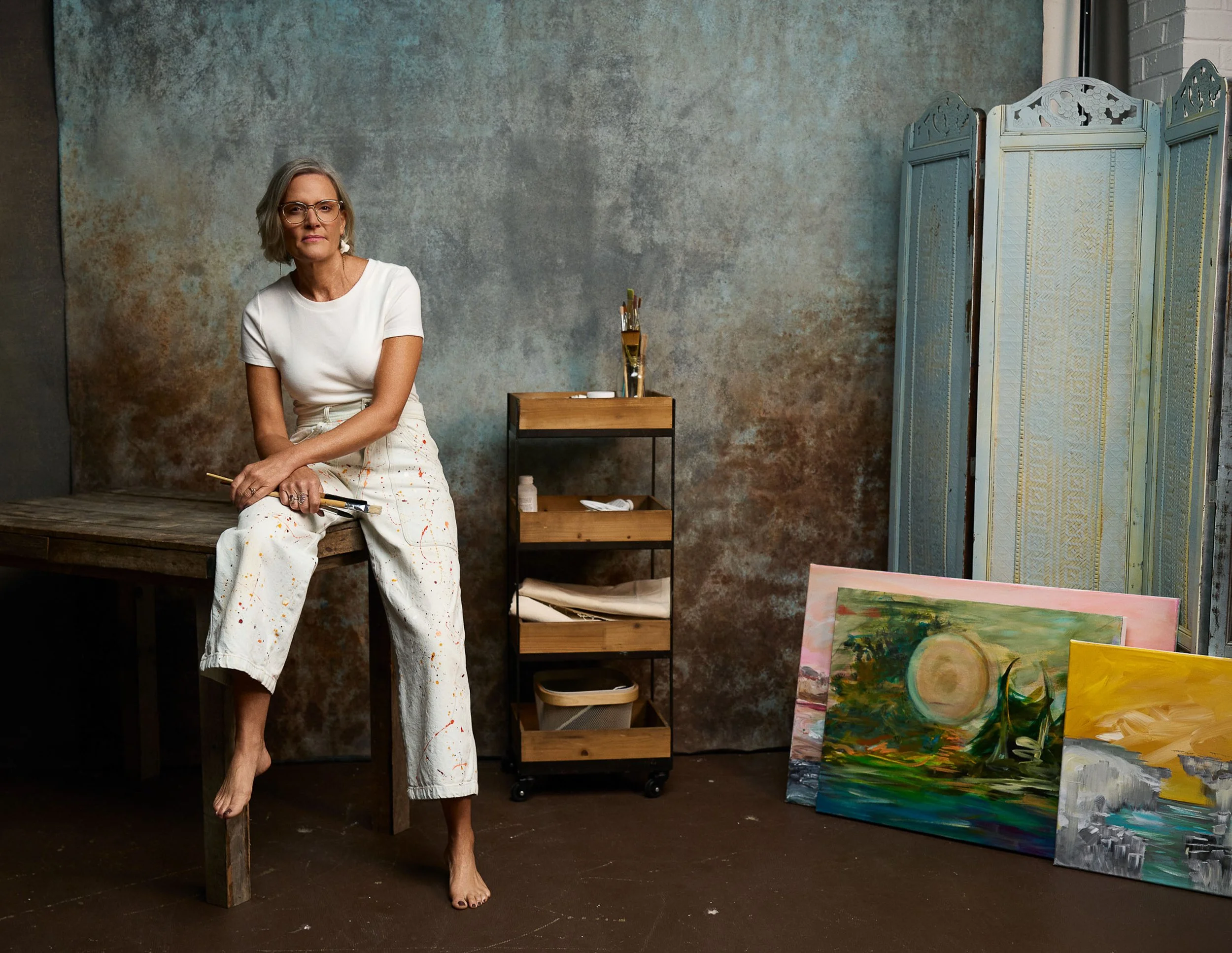 Personal branding photography of a visual artist in studio environment showing creativity and presence