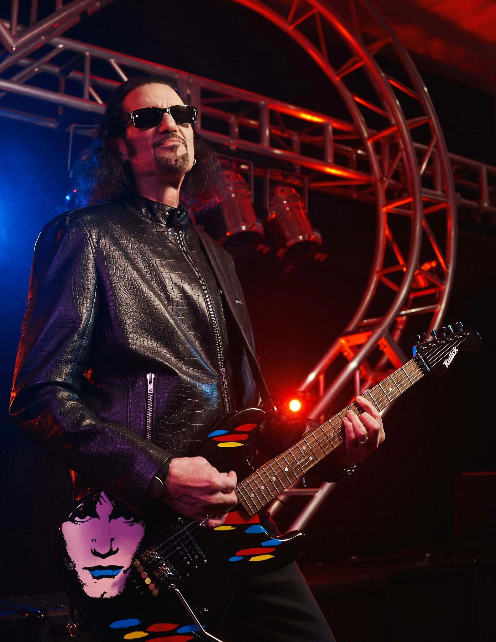 Bruce Kulick photographed with his signature guitar, reinforcing his identity as a defining voice in rock music