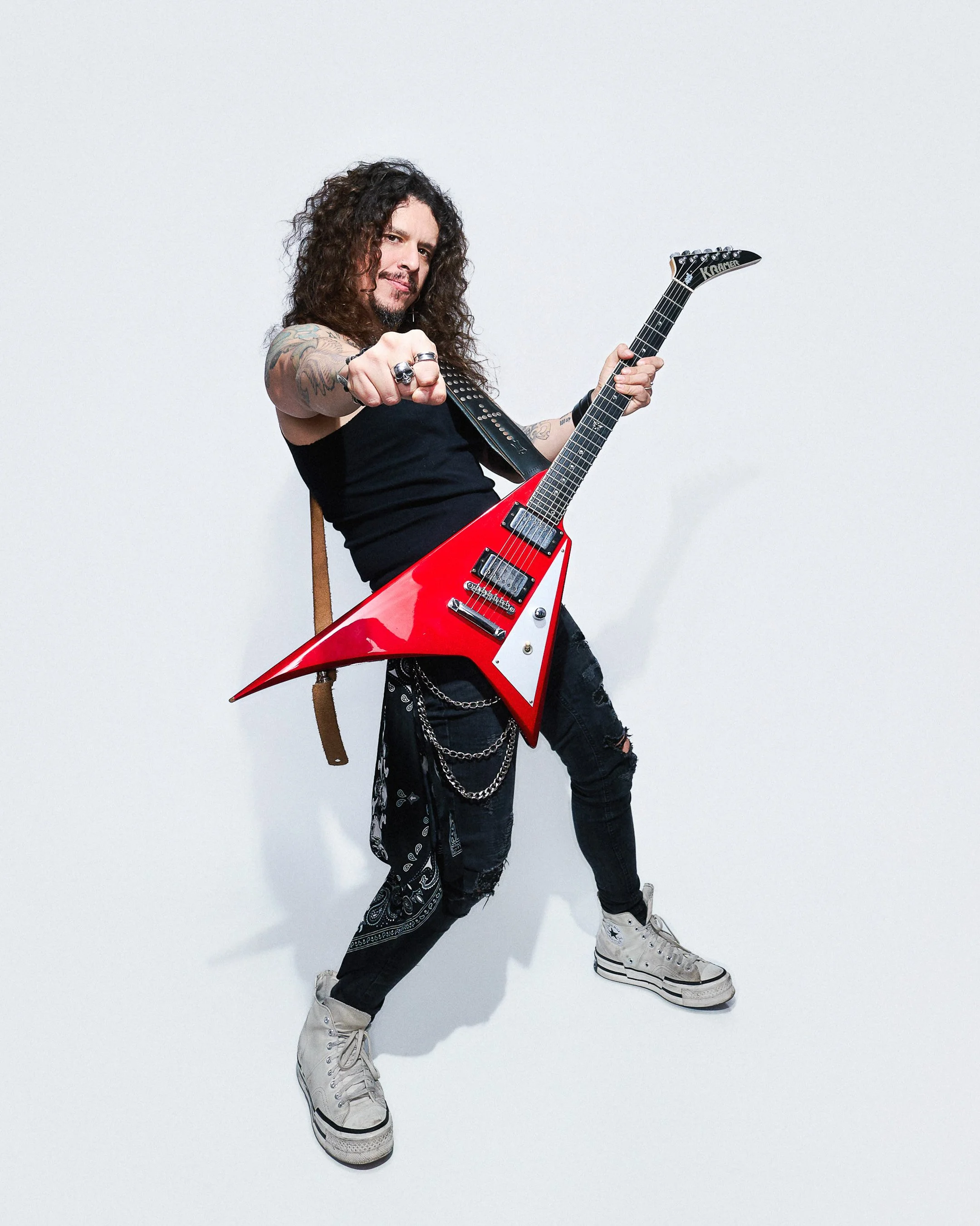 Personal branding portrait of a musician holding a guitar, bold and expressive studio photography