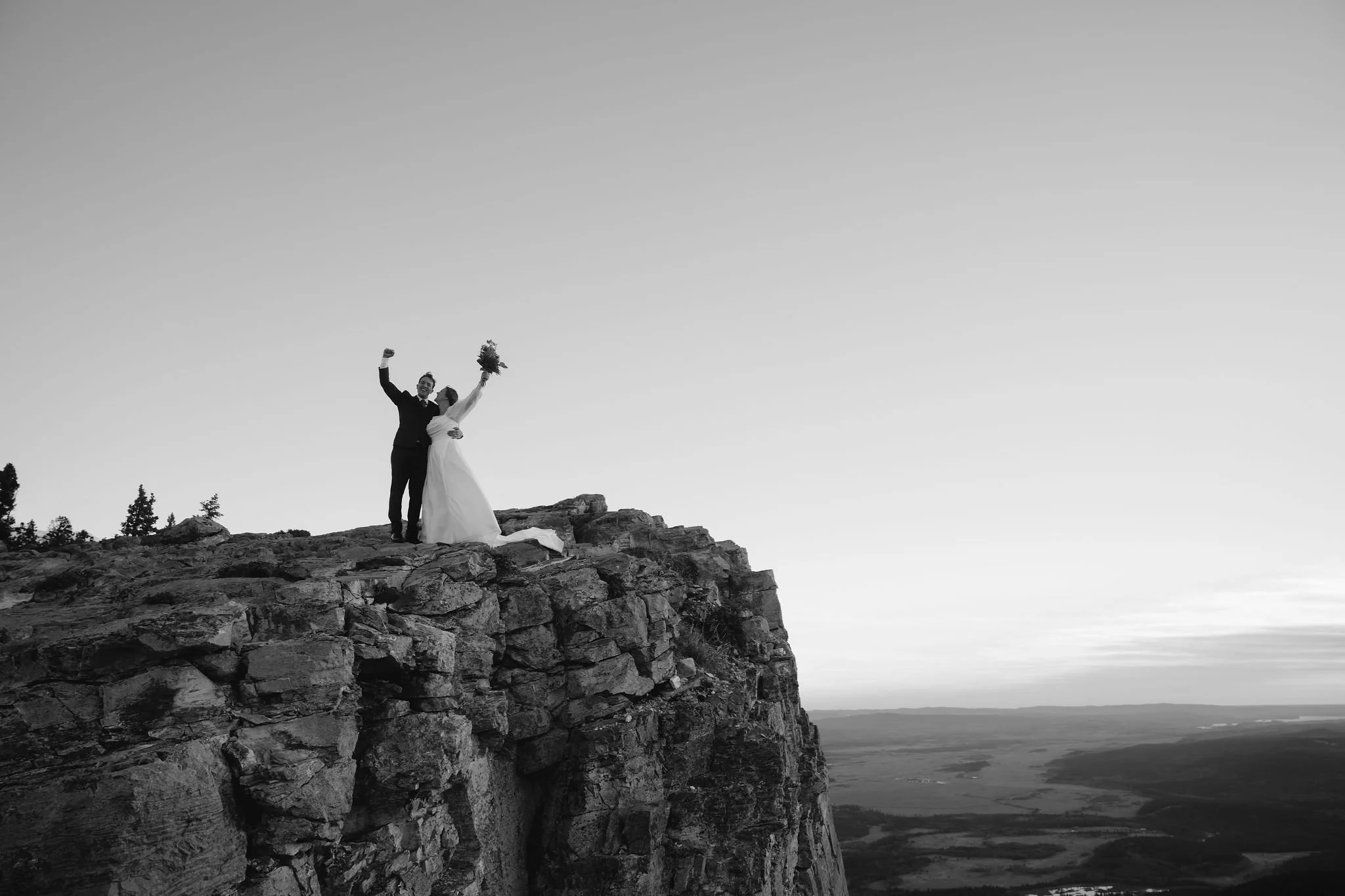 Couple on top of a mountain after hiking elopement