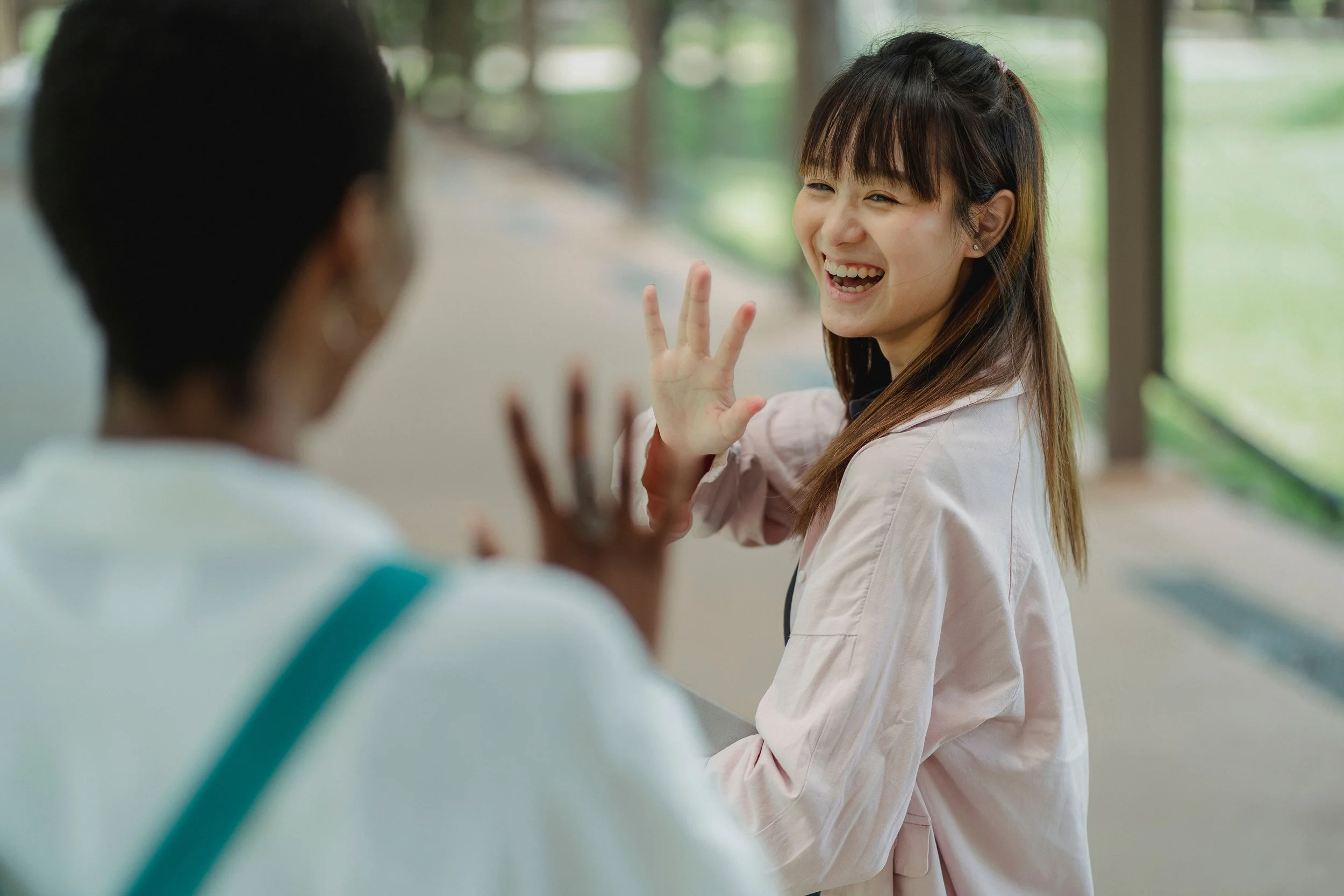 neighbors greeting each other with a wave
