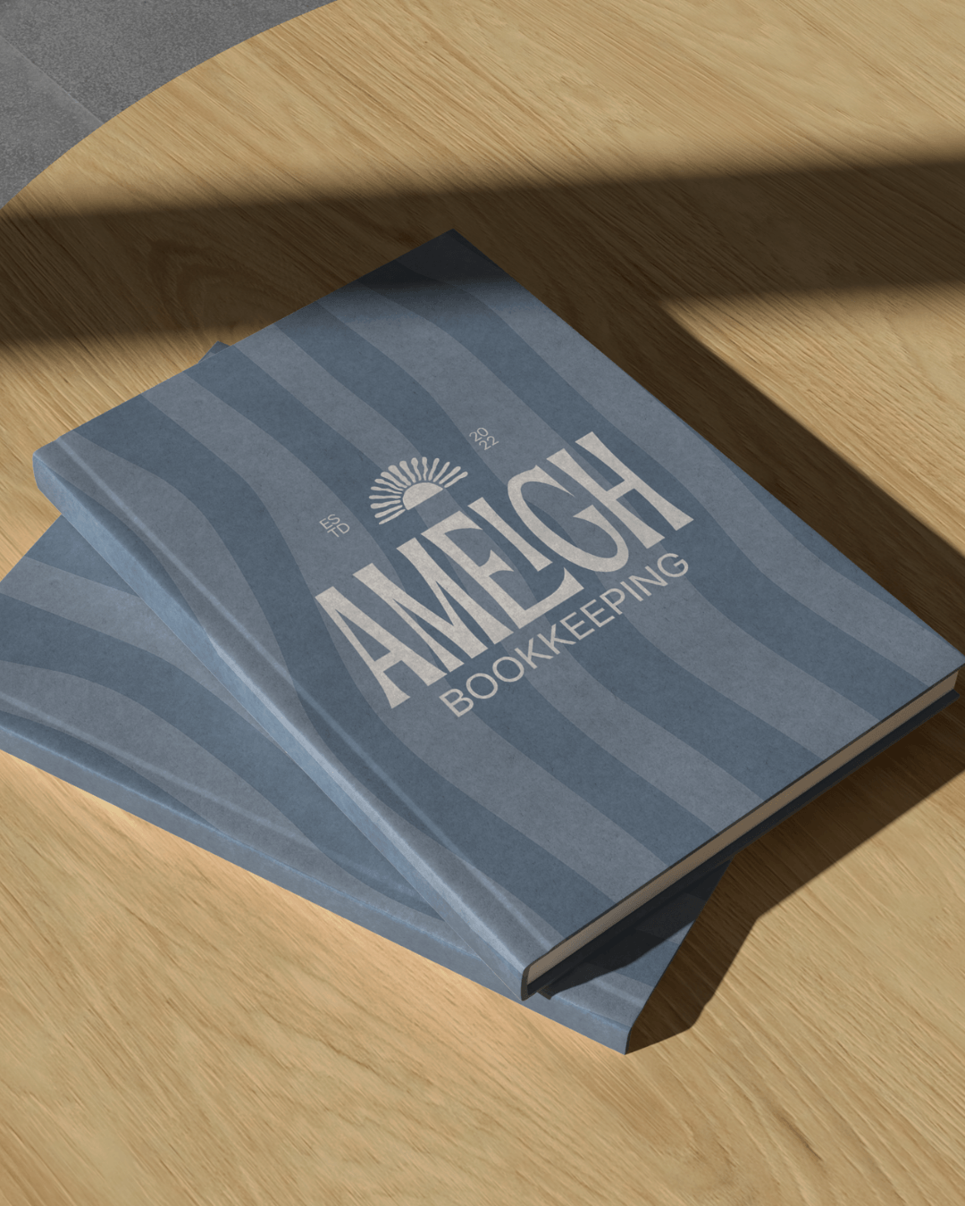 Ameigh Bookkeeping branded notebook design with soft blue tones and clean, modern logo