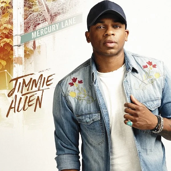 Album cover featuring a person in a denim shirt with floral embroidery, wearing a cap. Text reads "Jimmie Allen." Street sign for Mercury Lane is visible.