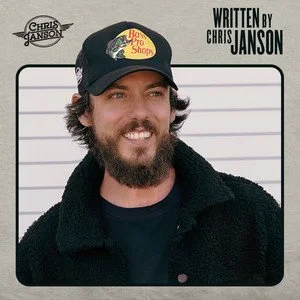 A man with a beard wearing a black cap and a dark jacket, smiling in front of a striped background. Text reads "Written by Chris Janson."