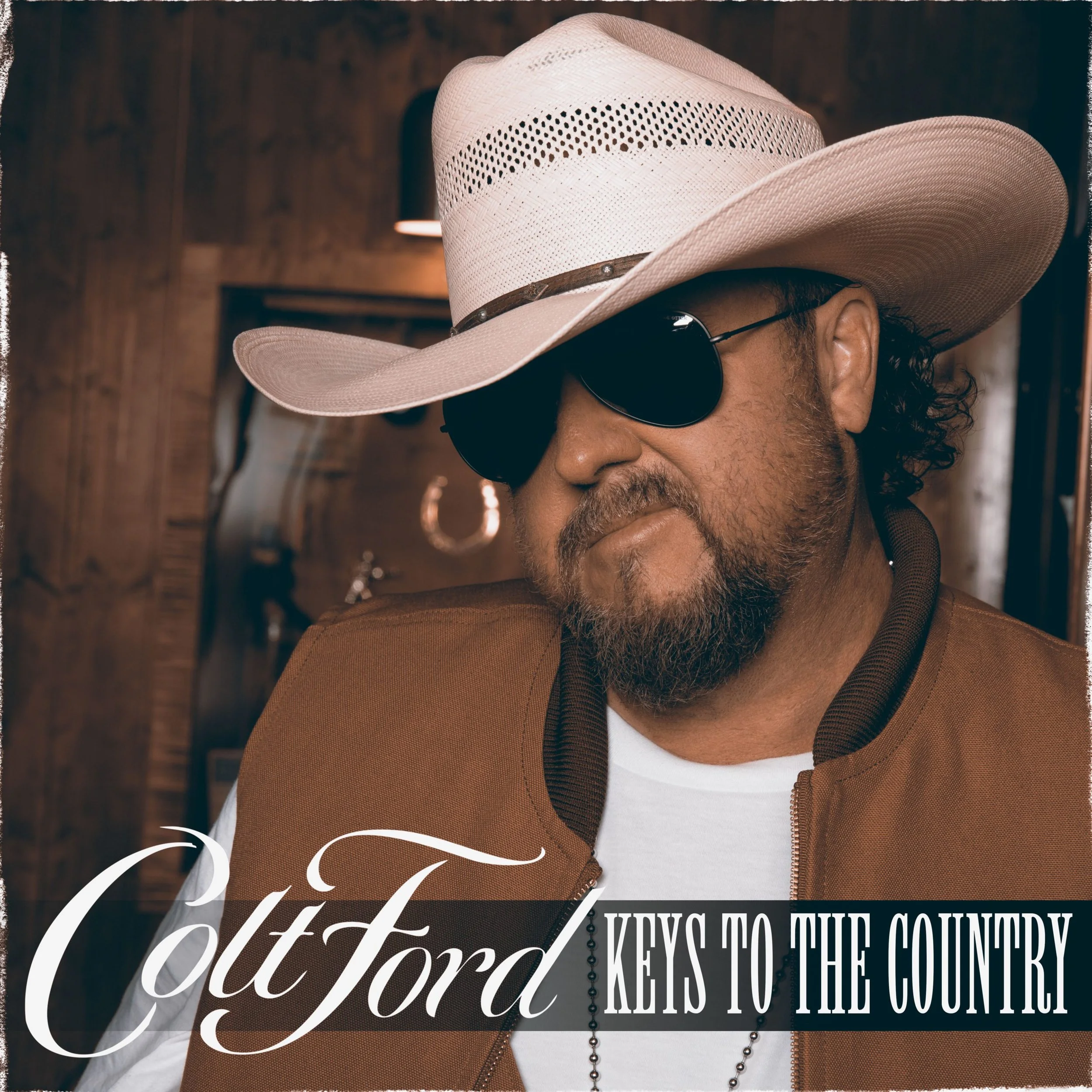 A man wearing a cowboy hat and sunglasses, labeled "Colt Ford Keys to the Country."