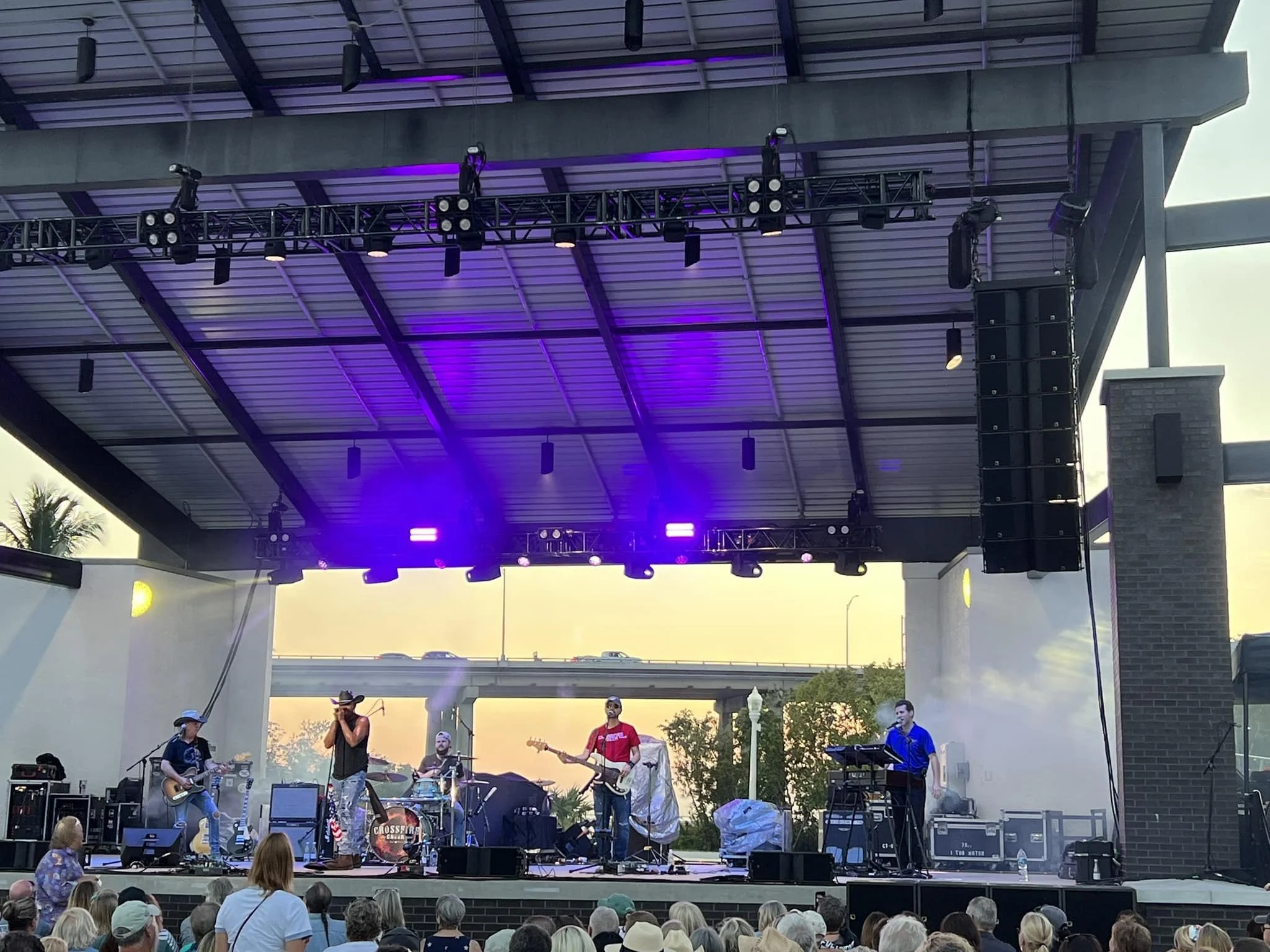 Outdoor concert with a band performing on stage
