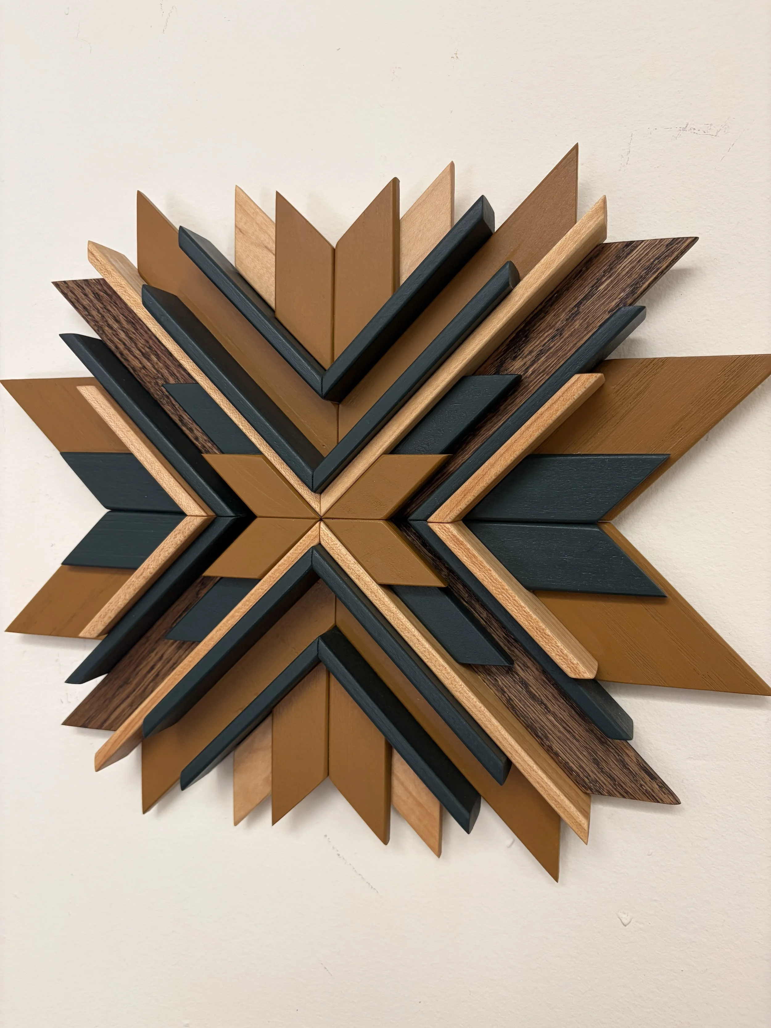 Side view of a wooden sunburst style mosaic in green and yellow paint with natural and espresso stains.