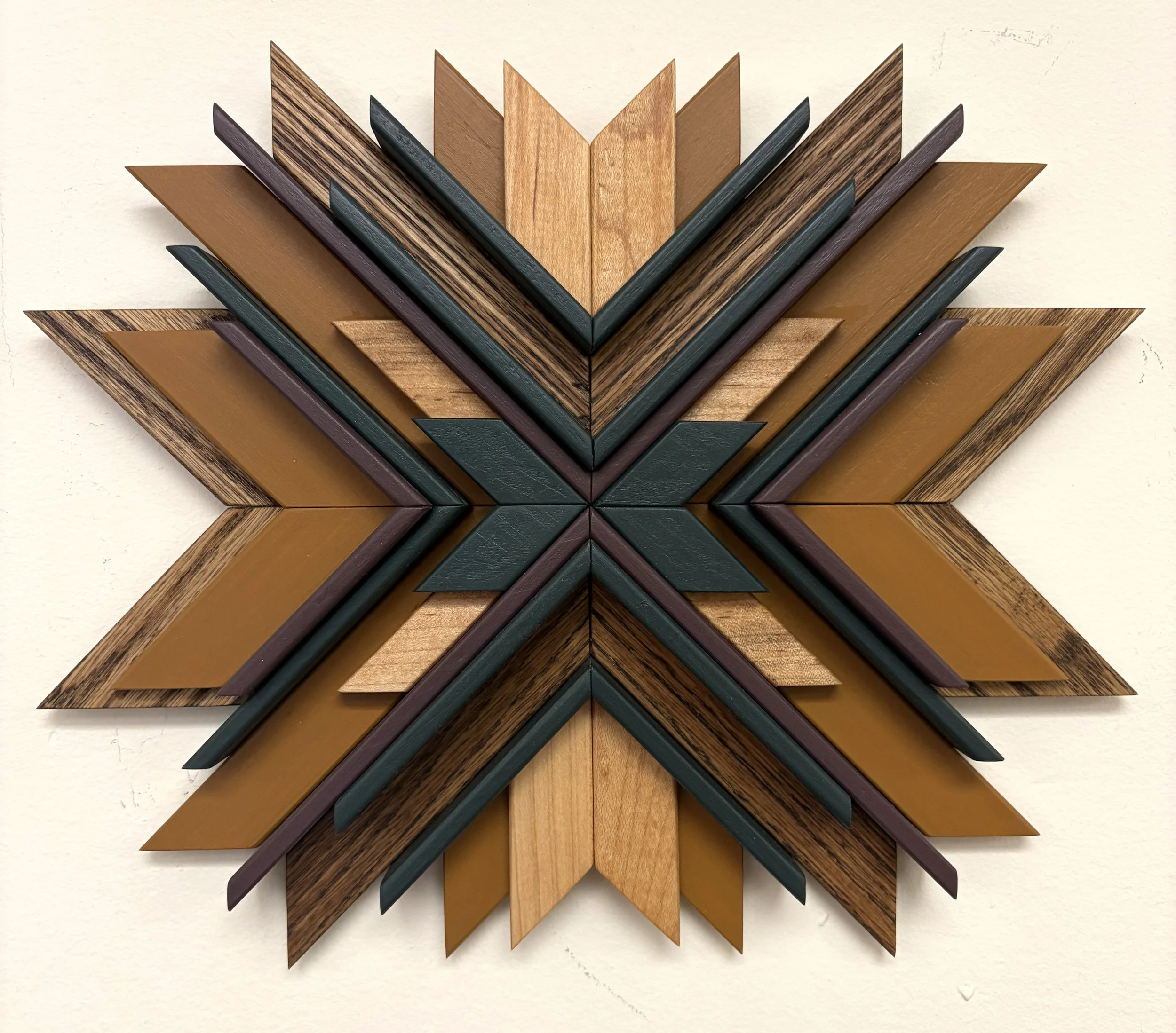 Wooden sunburst style mosaic in purple, green, and yellow paint with natural and espresso stains.