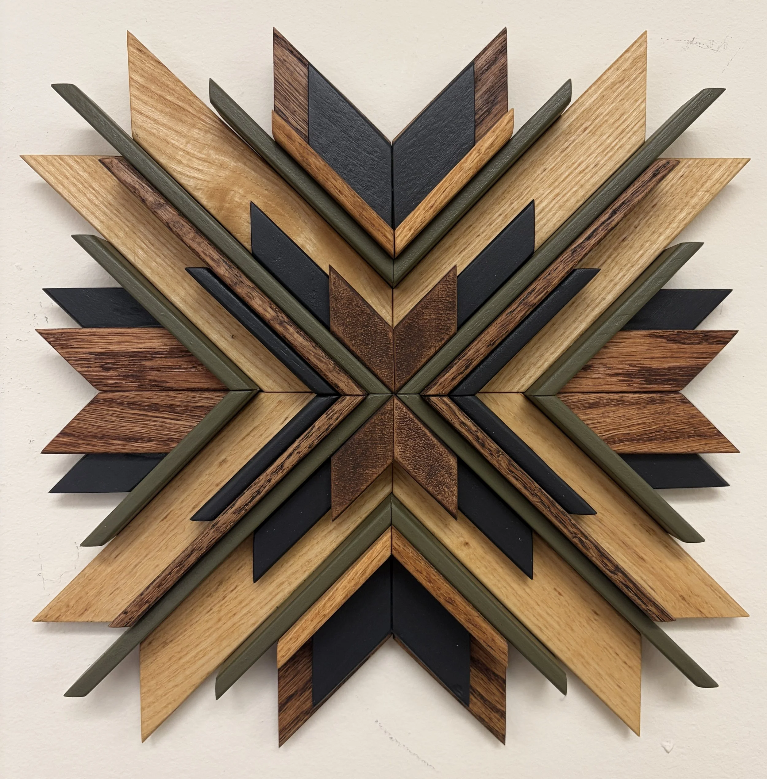 Wooden sunburst style mosaic in black and green paint with natural and espresso stains.