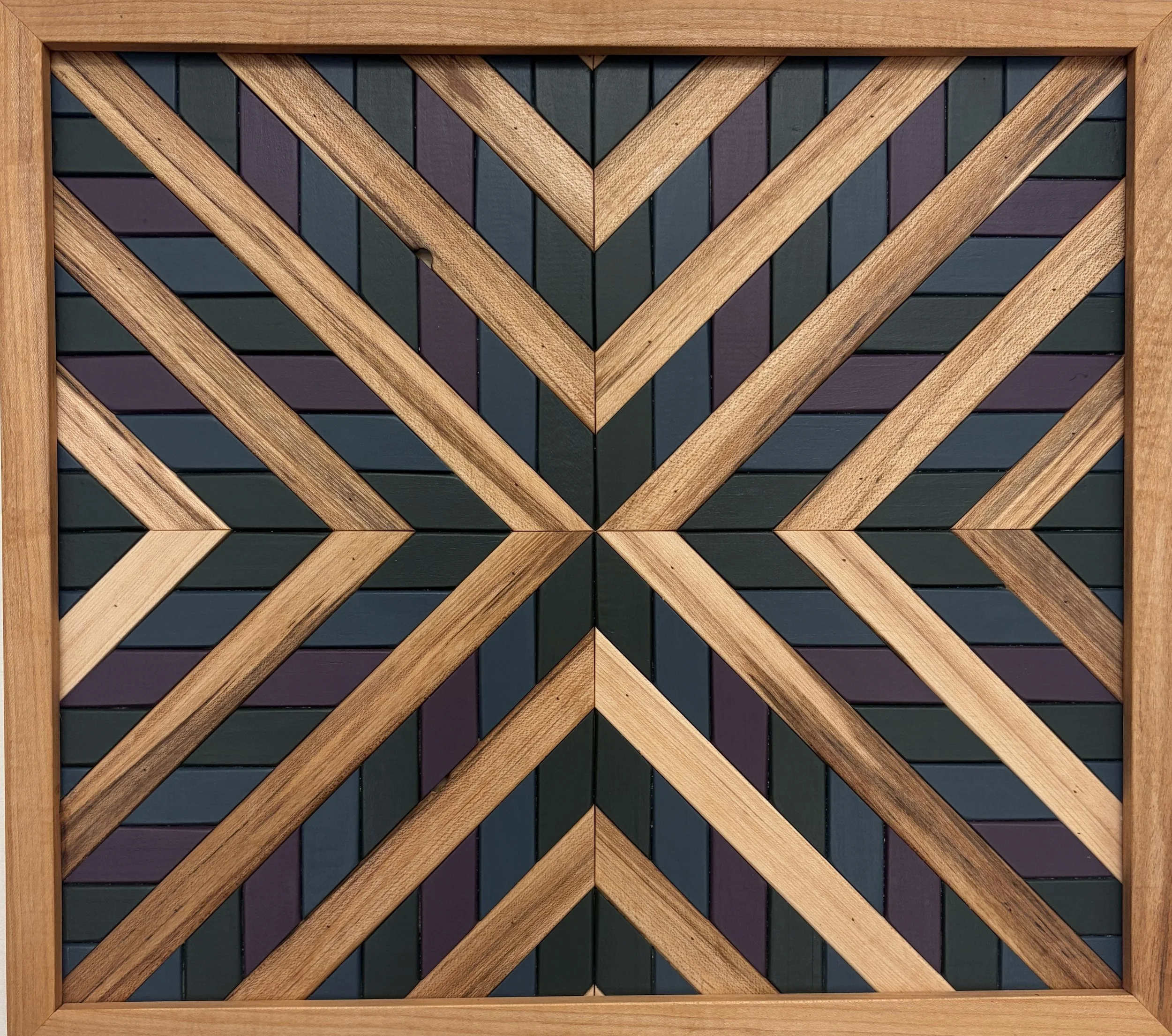Handcrafted framed wooden mosaic in green, purple, and blue paint with natural stains.