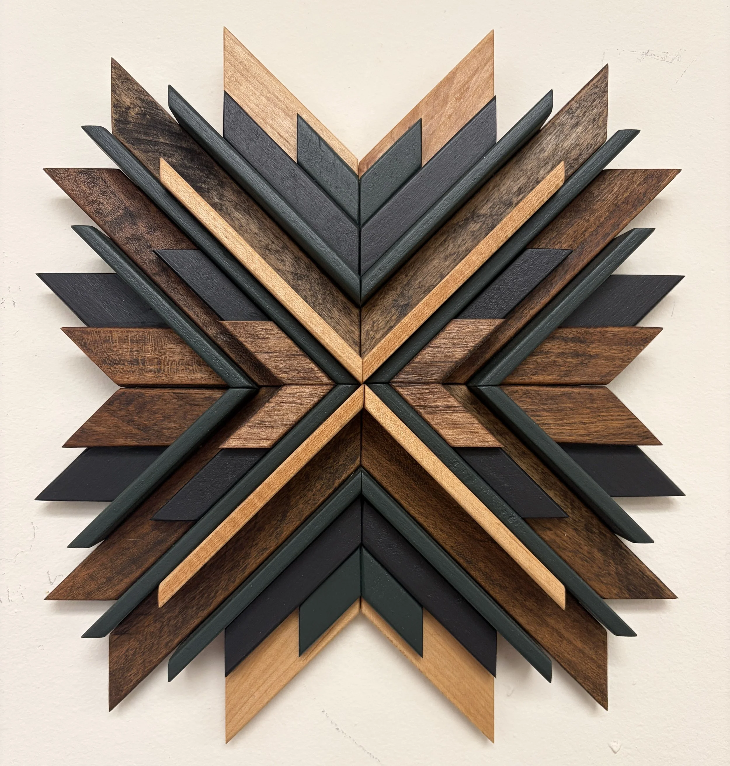 Wooden sunburst style mosaic in black and green paint with natural and espresso stains.