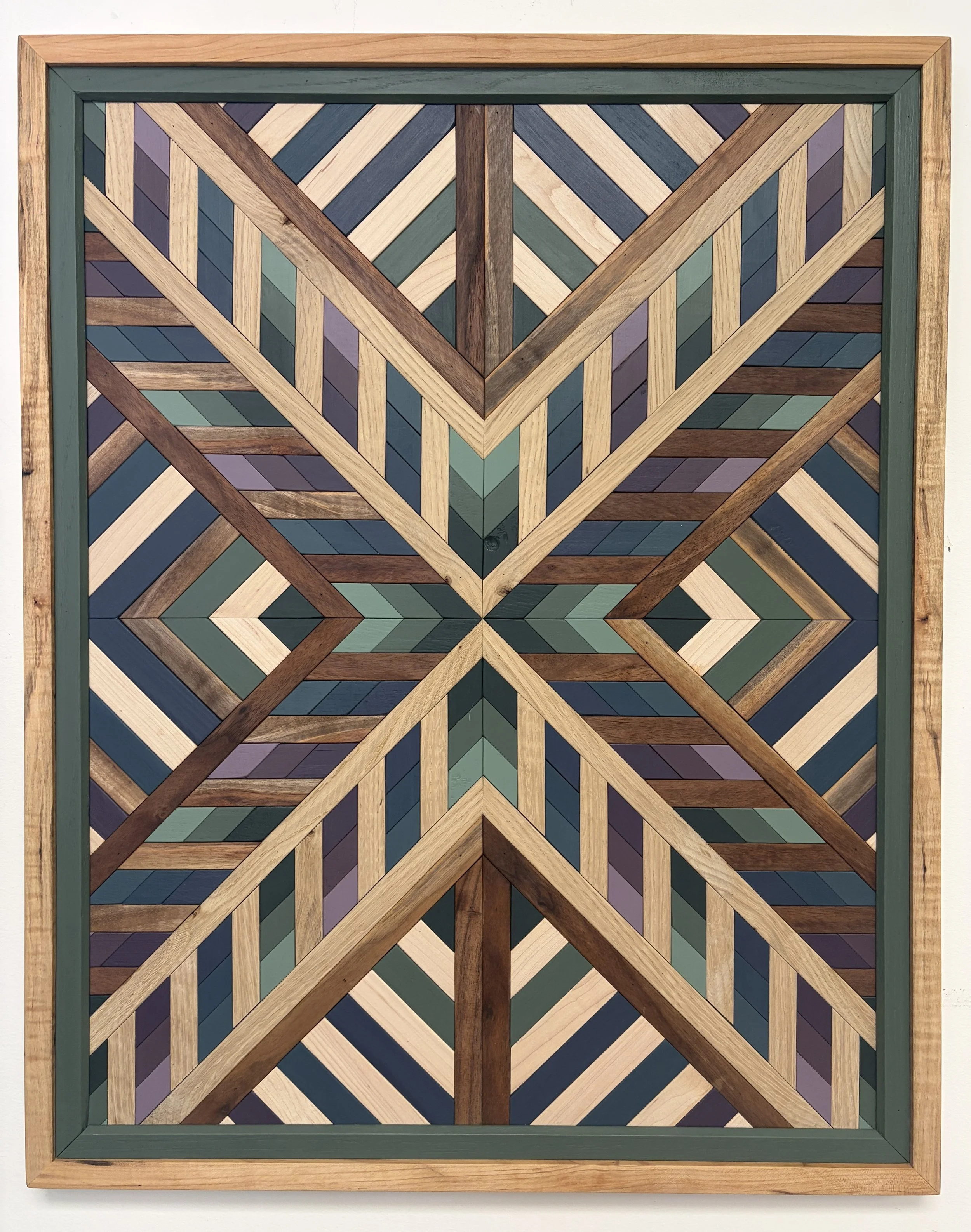 Handcrafted framed wooden mosaic in several shades of green, blue, and purple paint with natural wood stains.