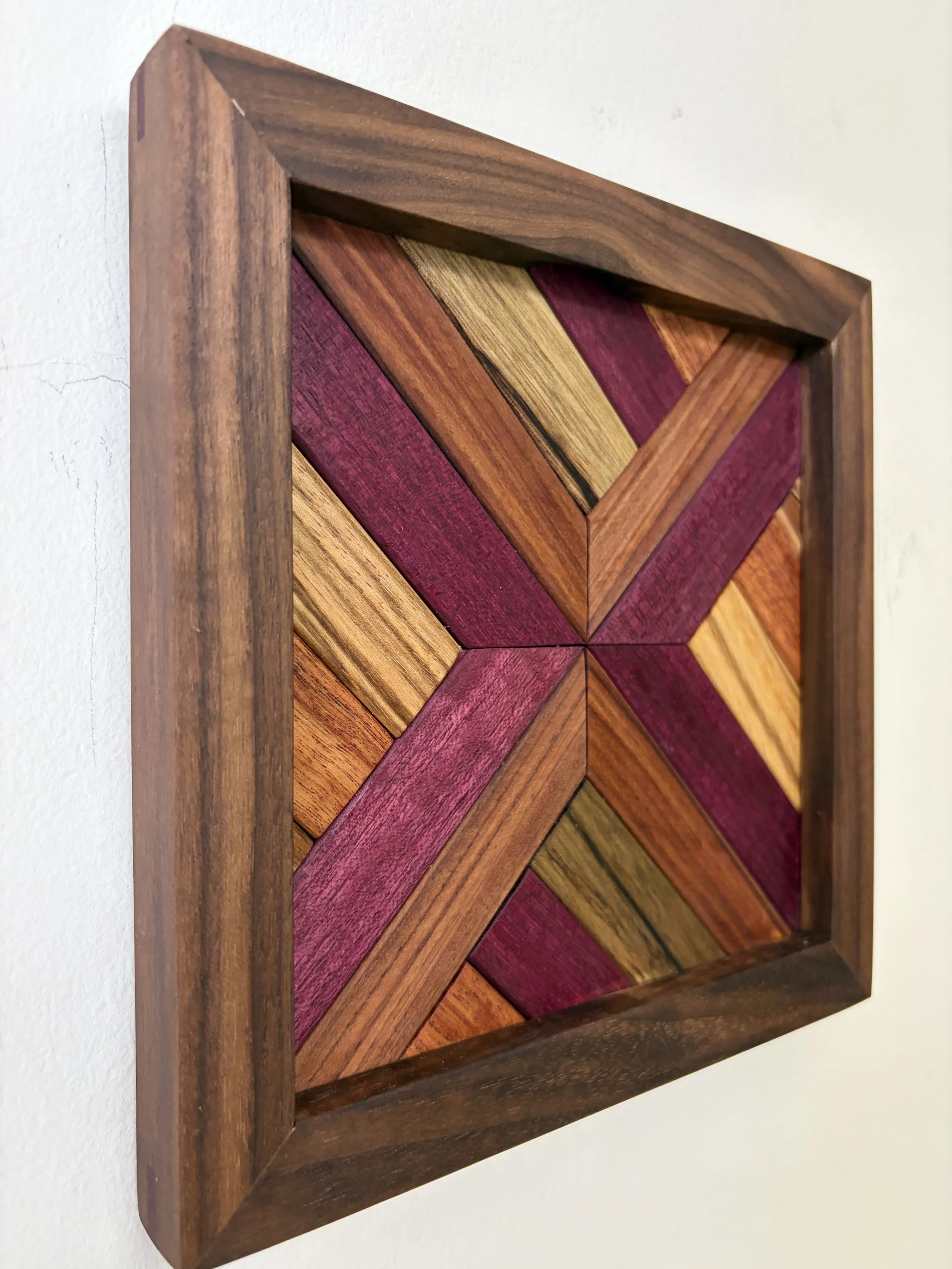 Side view of a handcrafted framed wooden mosaic made from various exotic woods.