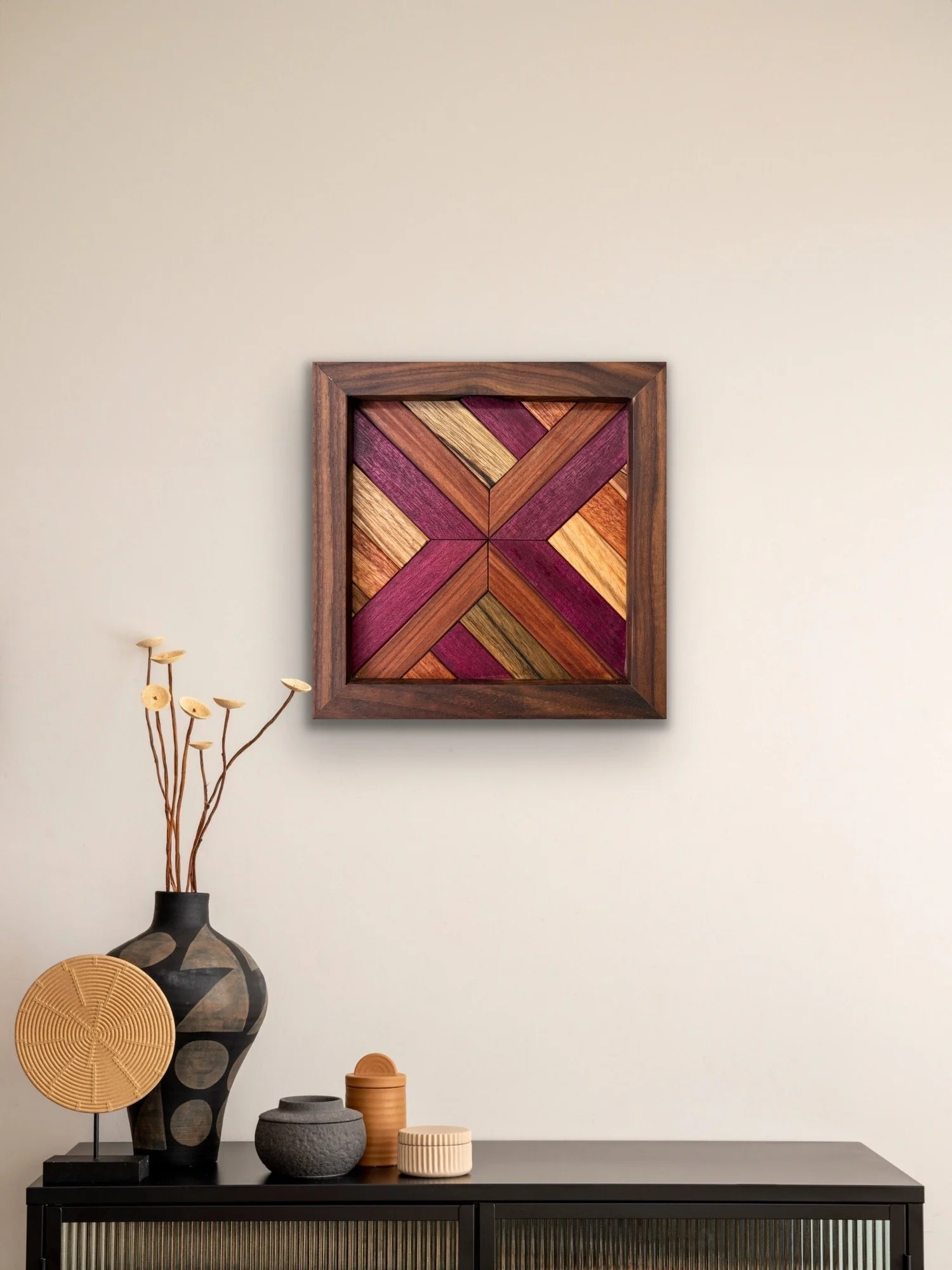 Handcrafted framed wooden mosaic made from various exotic woods hanging on a wall.