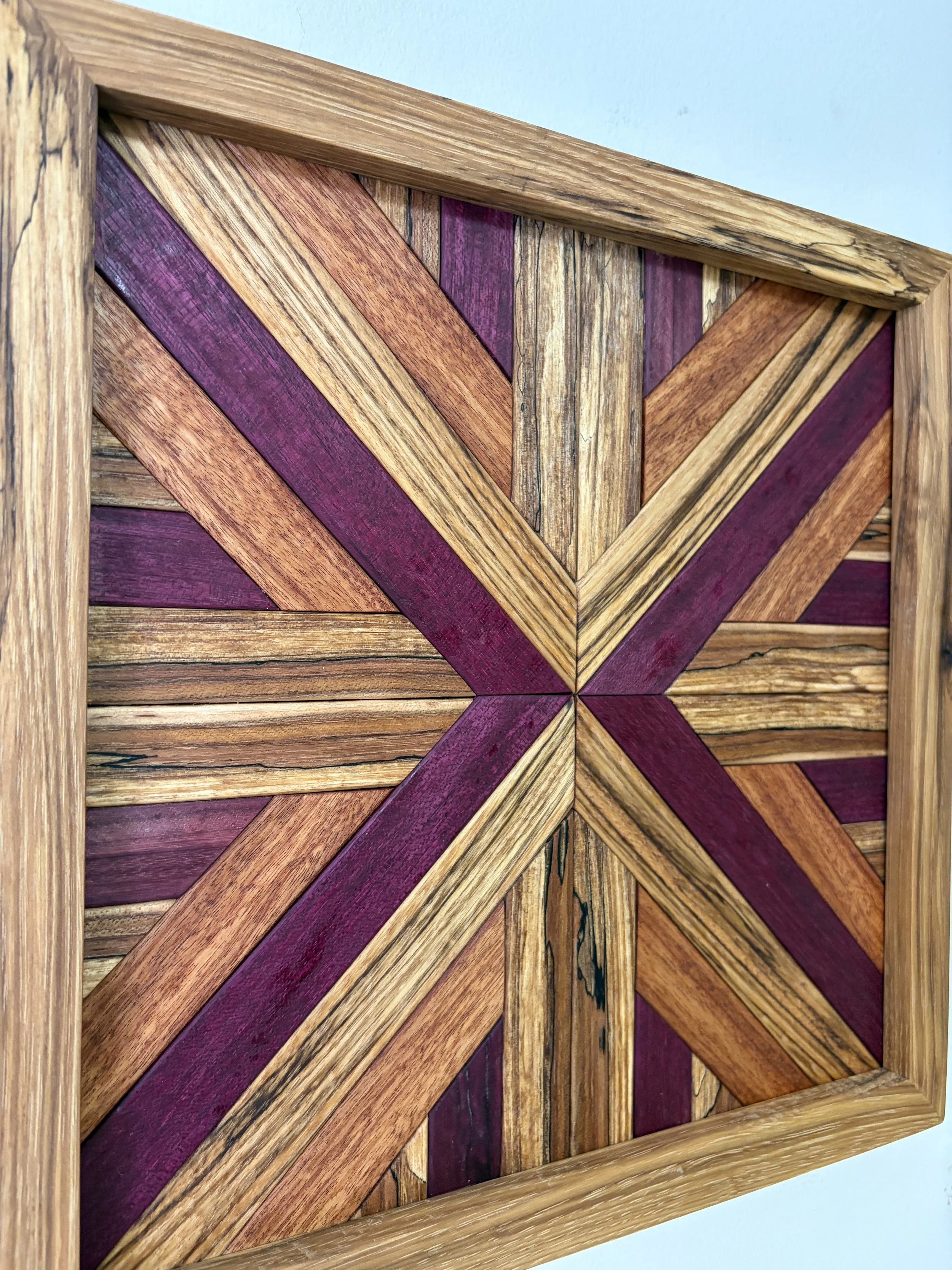 Side view of a handcrafted framed wooden mosaic made from various exotic woods.