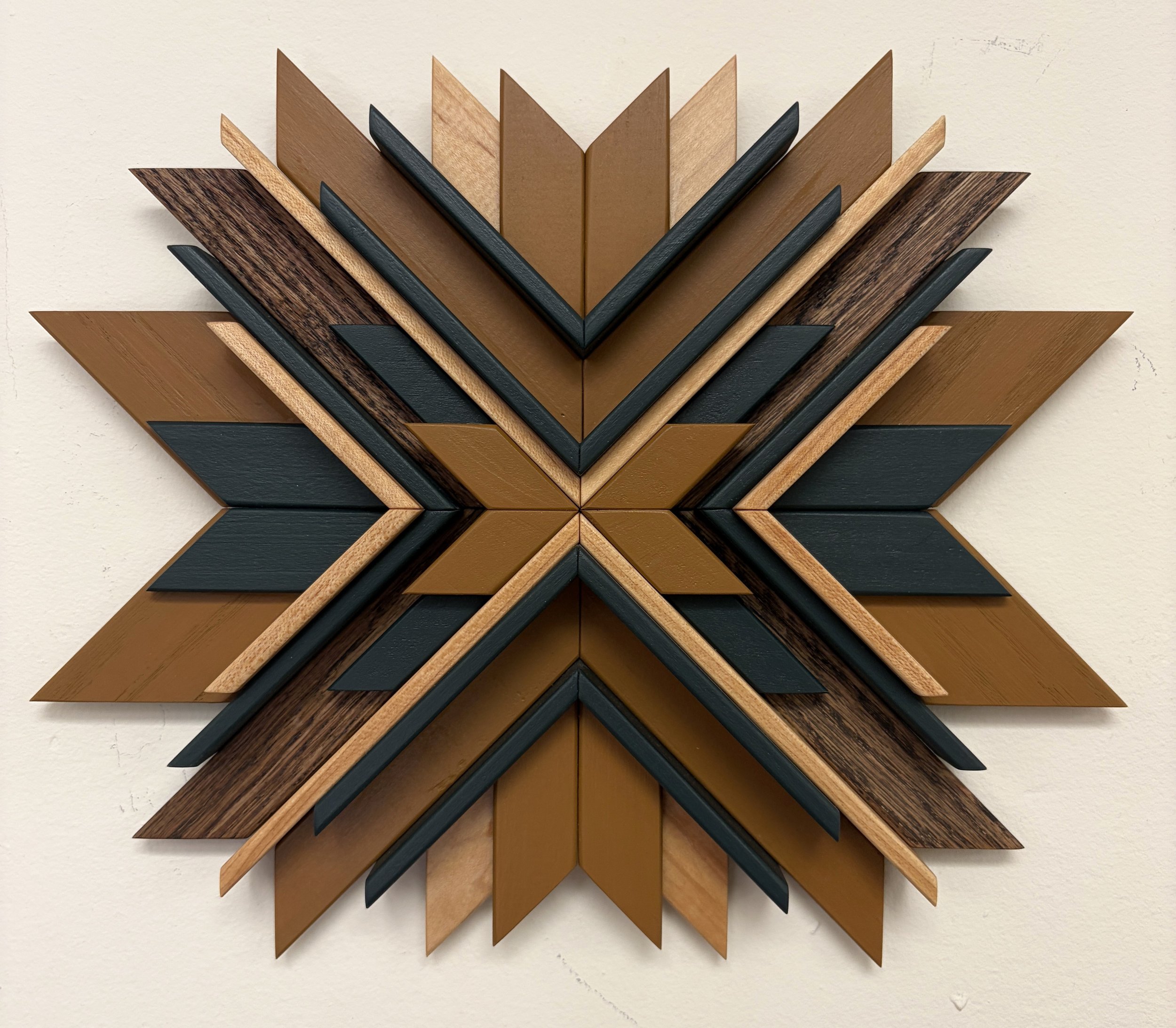 Wooden sunburst style mosaic in green and yellow paint with natural and espresso stains.
