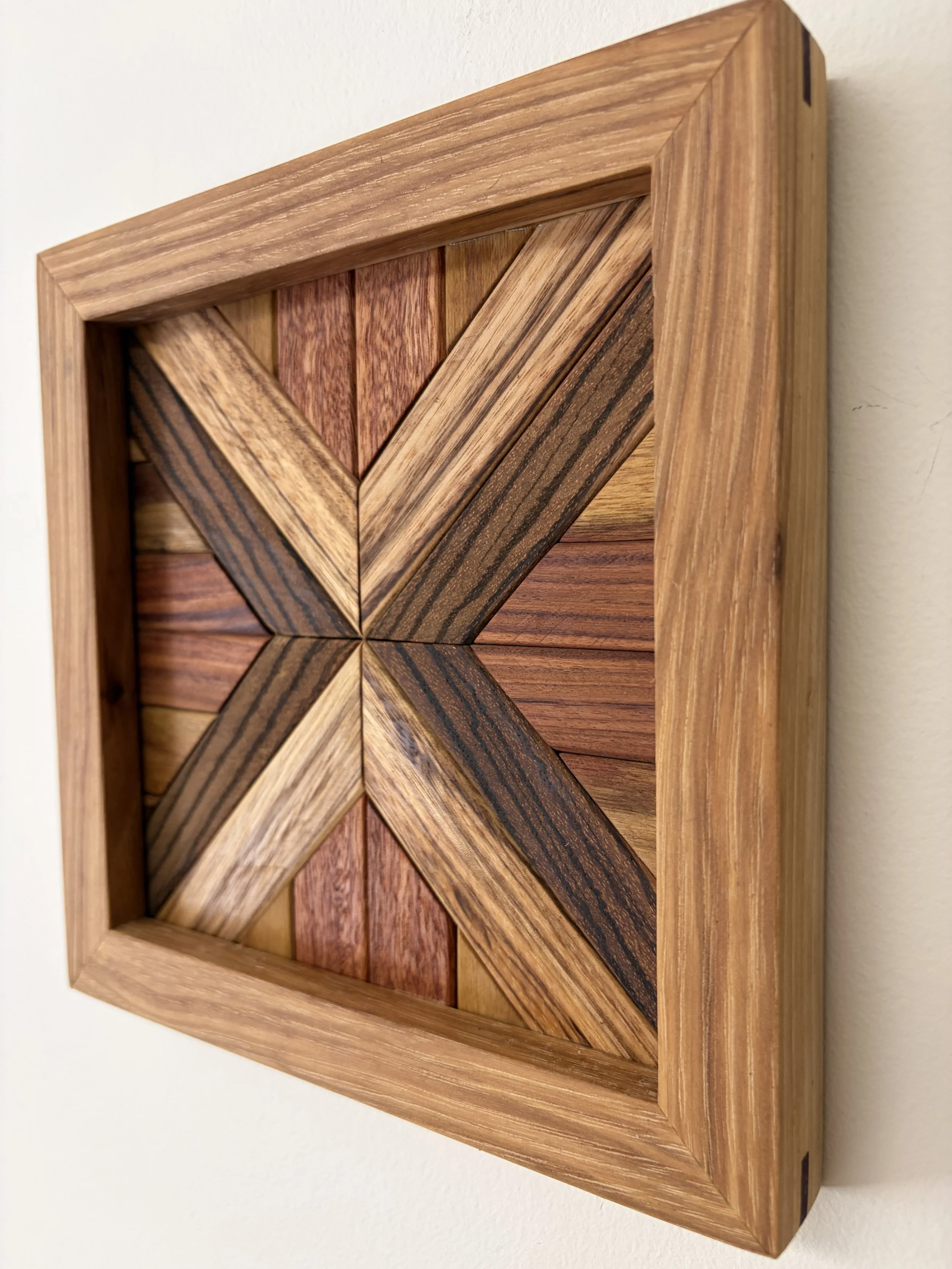 Side view of a handcrafted framed wooden mosaic made from various exotic woods.