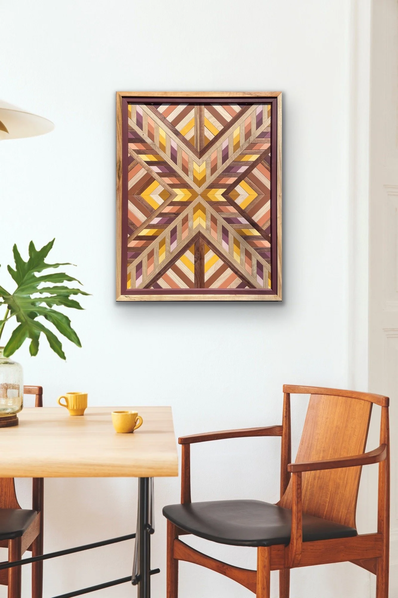 Framed wooden mosaic displayed on a wall.