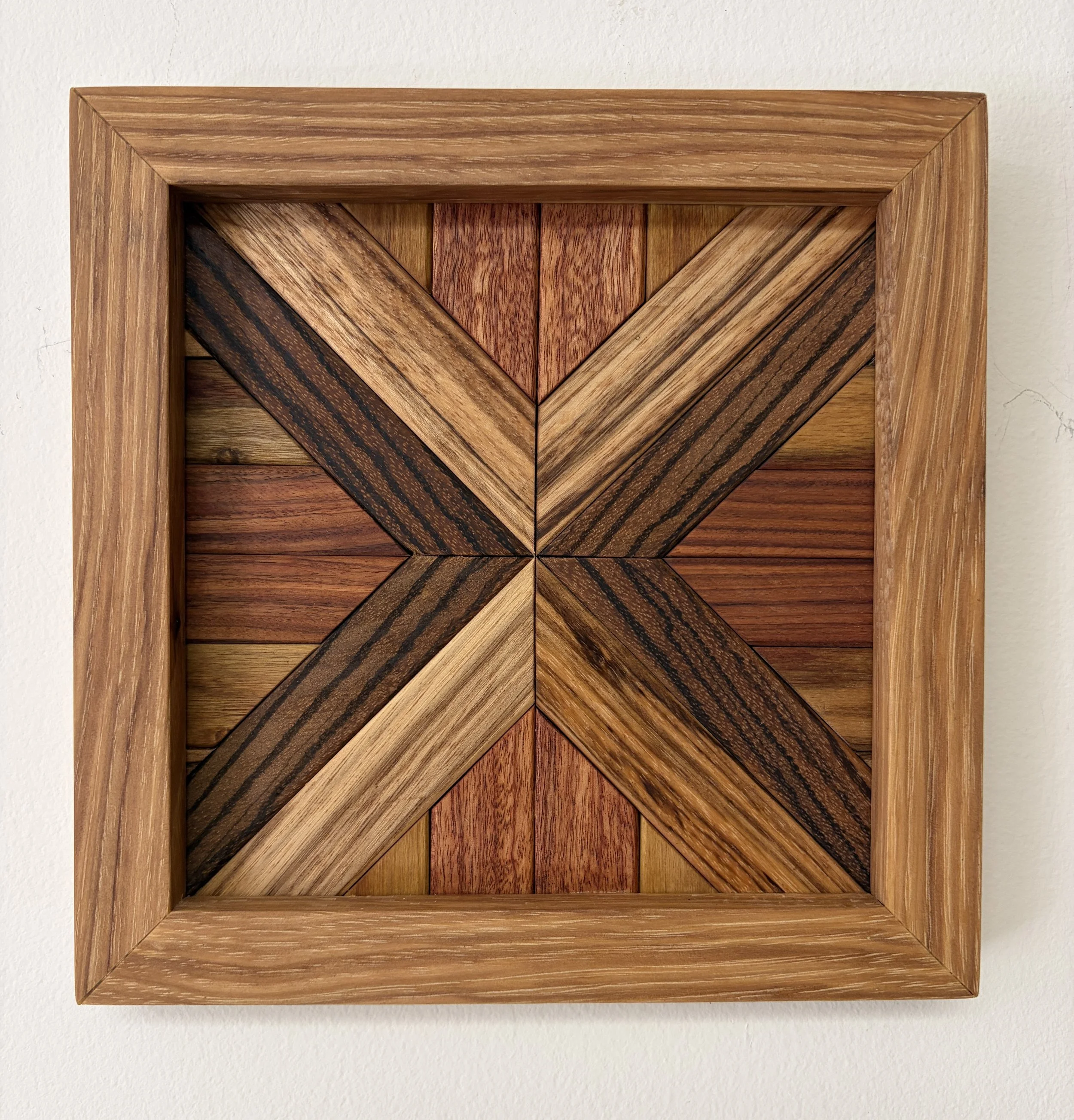 Handcrafted framed wooden mosaic made from various exotic woods.