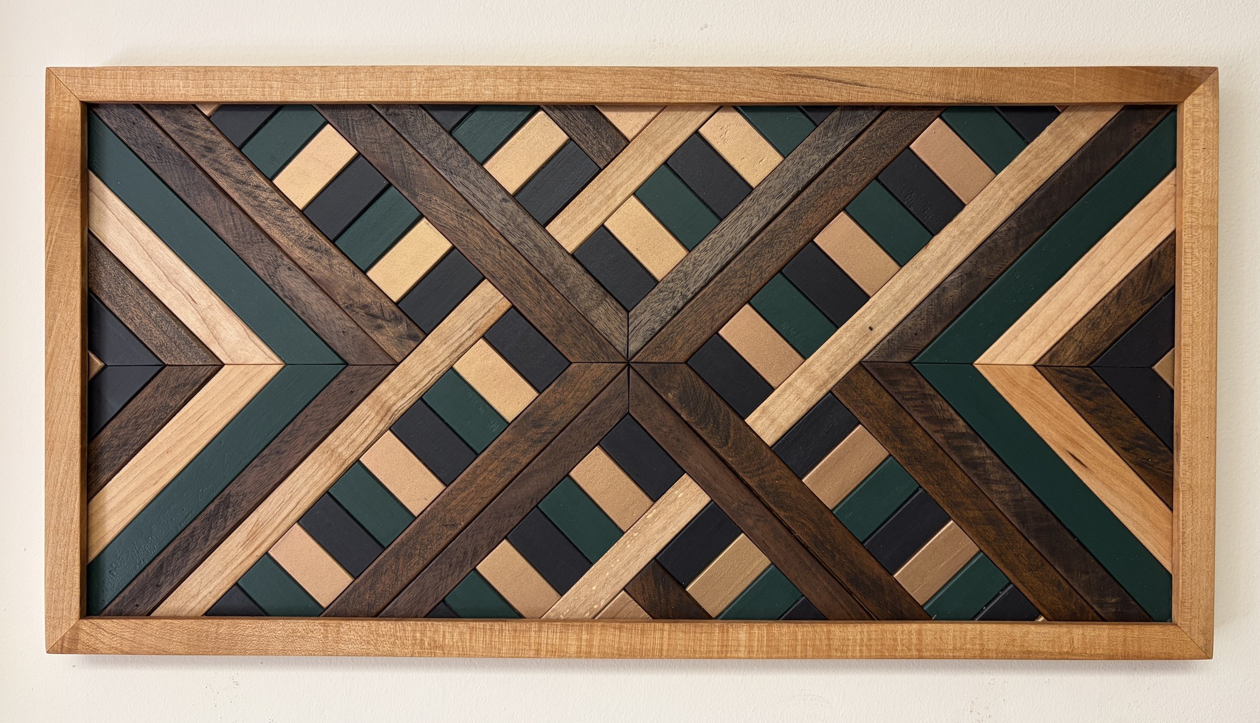 Handcrafted framed wooden mosaic in black, green, and gold paint with natural and espresso stains.