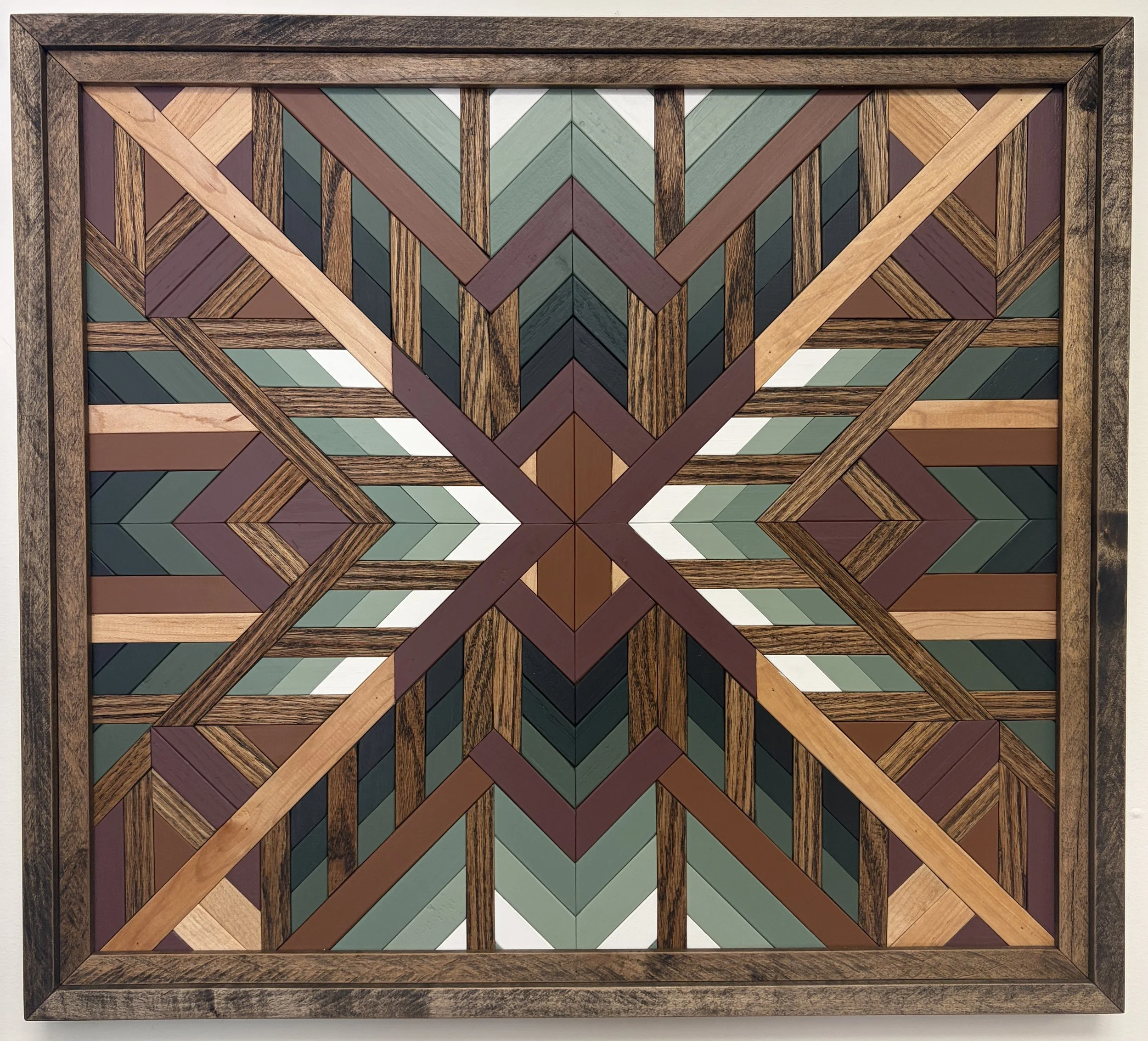 Handcrafted framed wooden mosaic in black, white, pink, orange, and various green paints with natural and espresso stains.