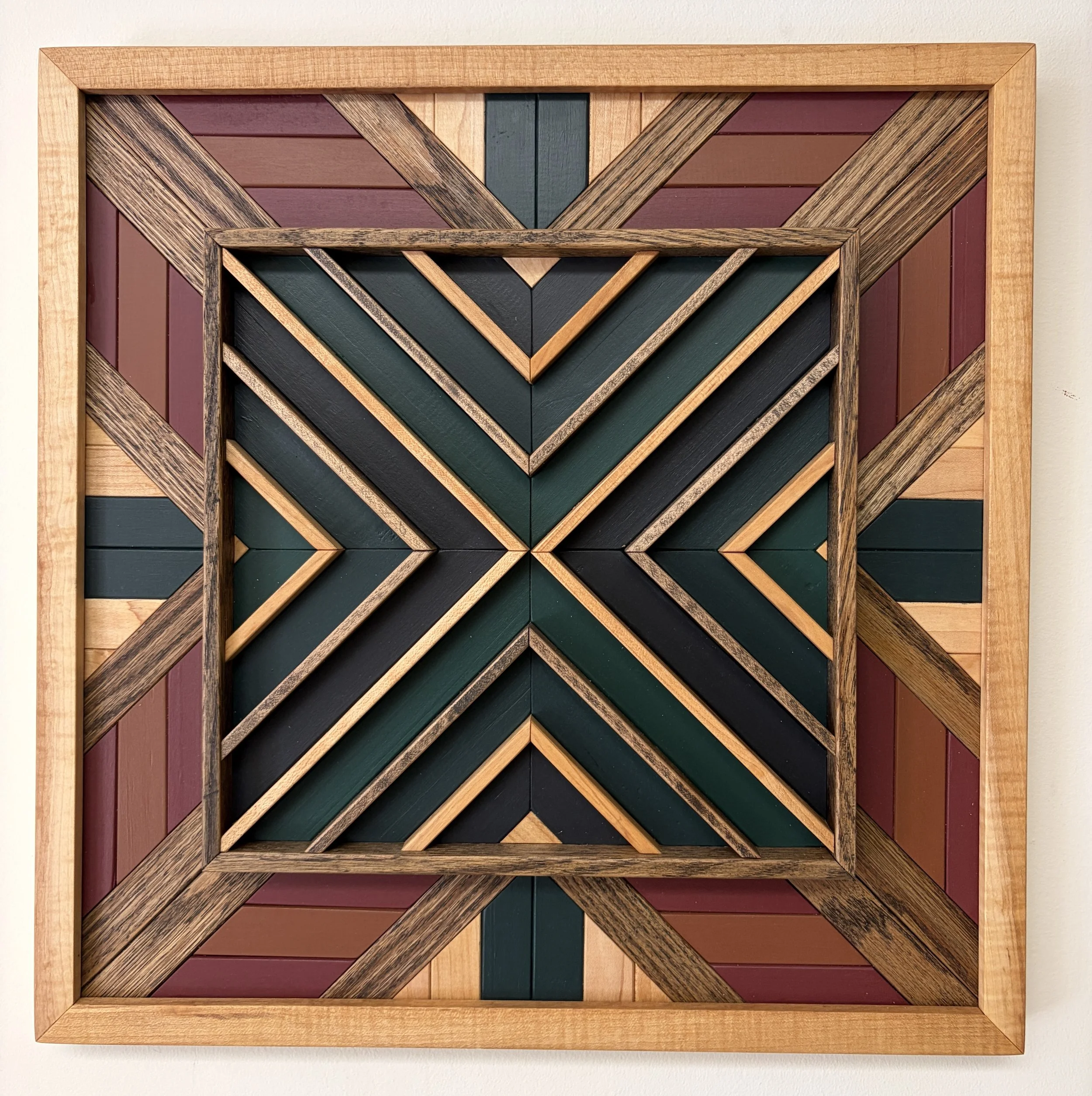Handcrafted framed wooden mosaic in black, green, teal, pink, and orange paint with natural and espresso stains.