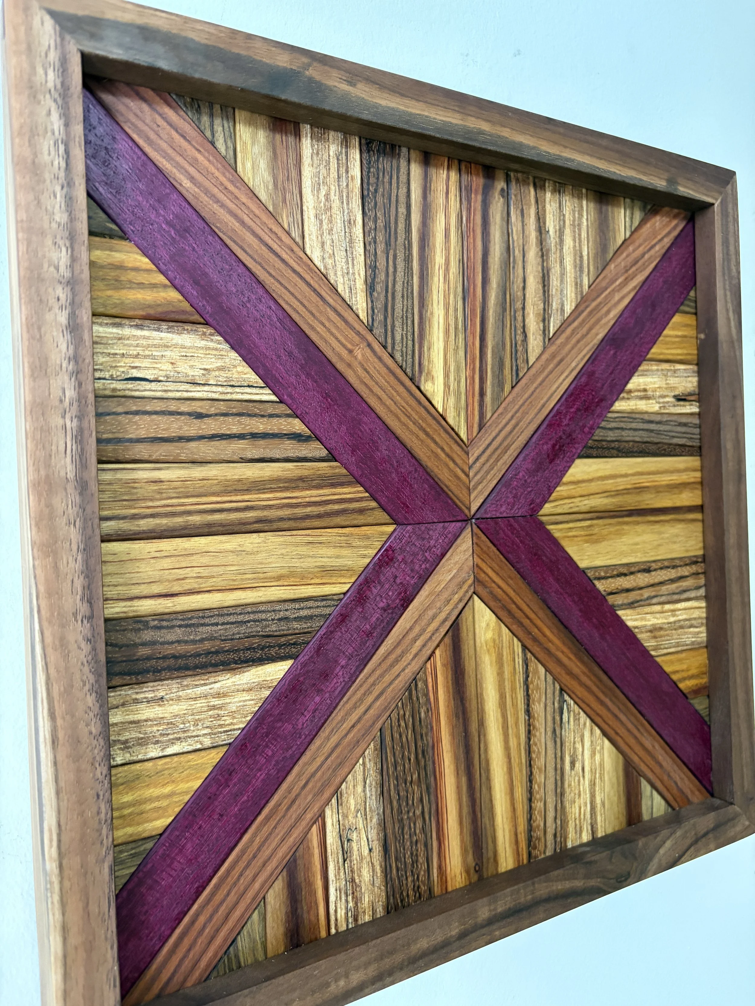 Side view of a handcrafted framed wooden mosaic made from various exotic woods.