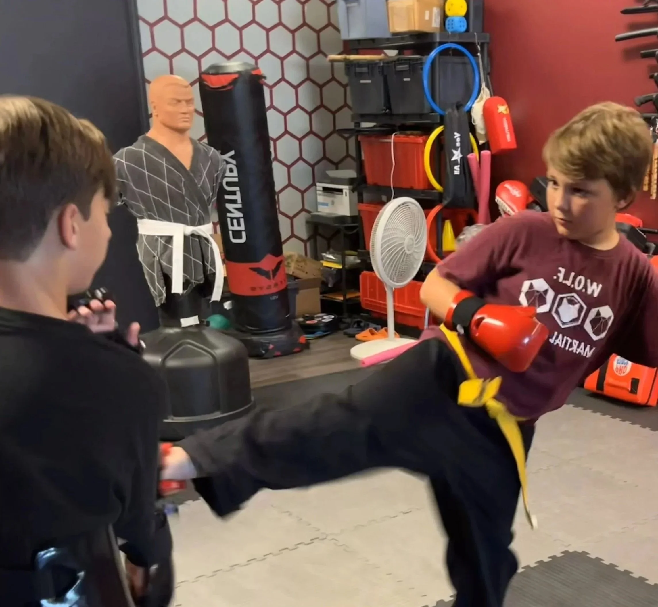 Youth martial arts student kicking at W.O.L.F. Martial Arts in Lenexa