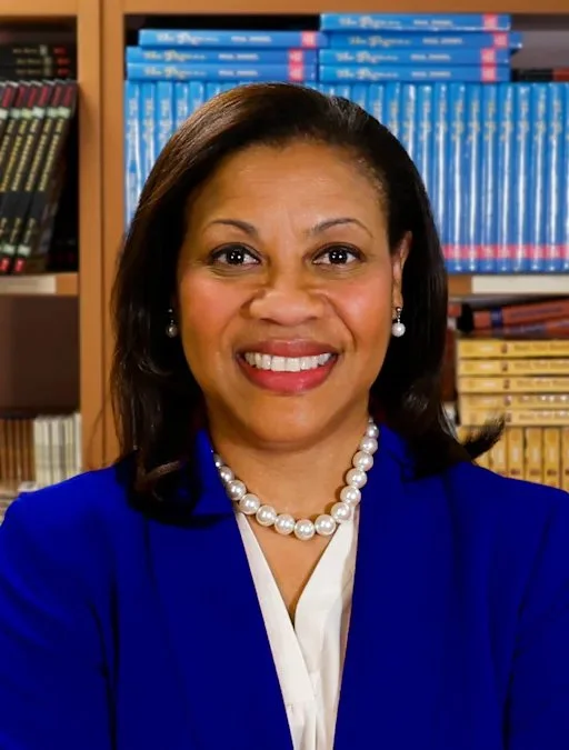 Portrait of a woman smiling in a blue jacket, labeled as Superintendent of Schools, Dr. Laurie W. Newell.