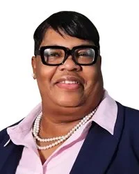 Portrait of a woman labeled "Commissioner Ms. Oshin Castillo-Cruz".