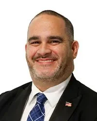 Portrait of a man labeled Commissioner, Mr. Mohammed H. Rashid.