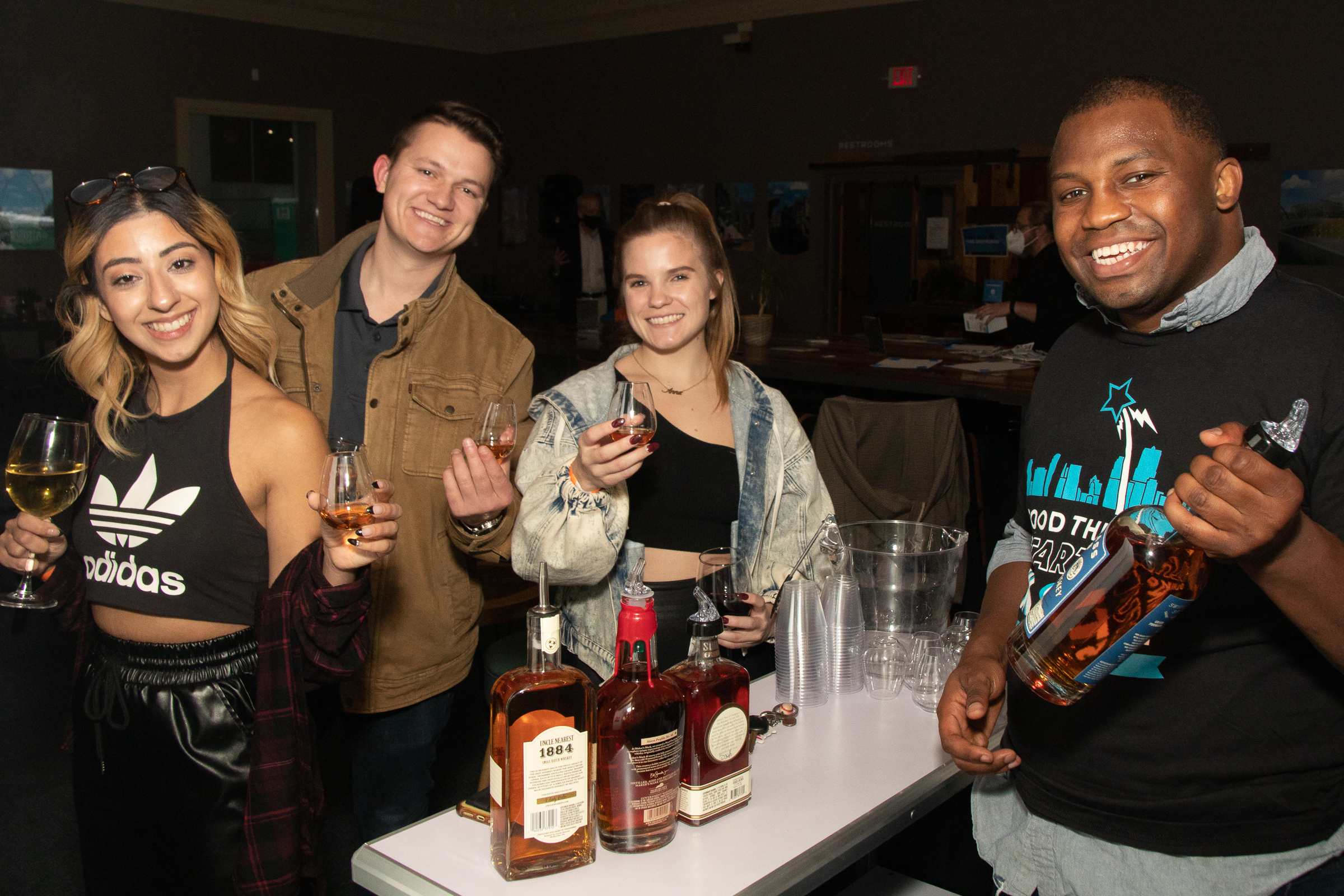 Men and Women drinking bourbon at an event