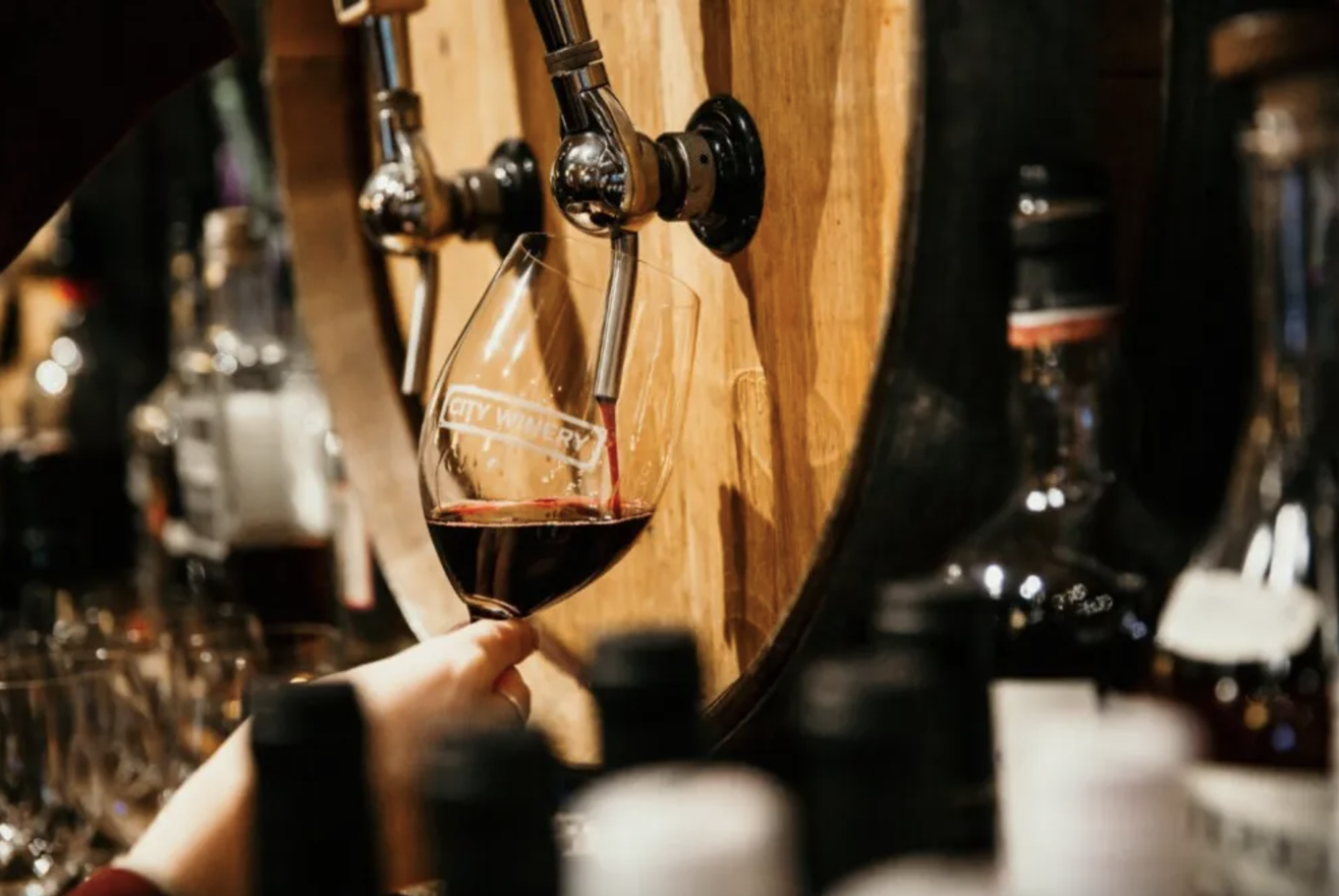 A wine glass being filled from a barrel at City Winery in St. Louis' City Foundry