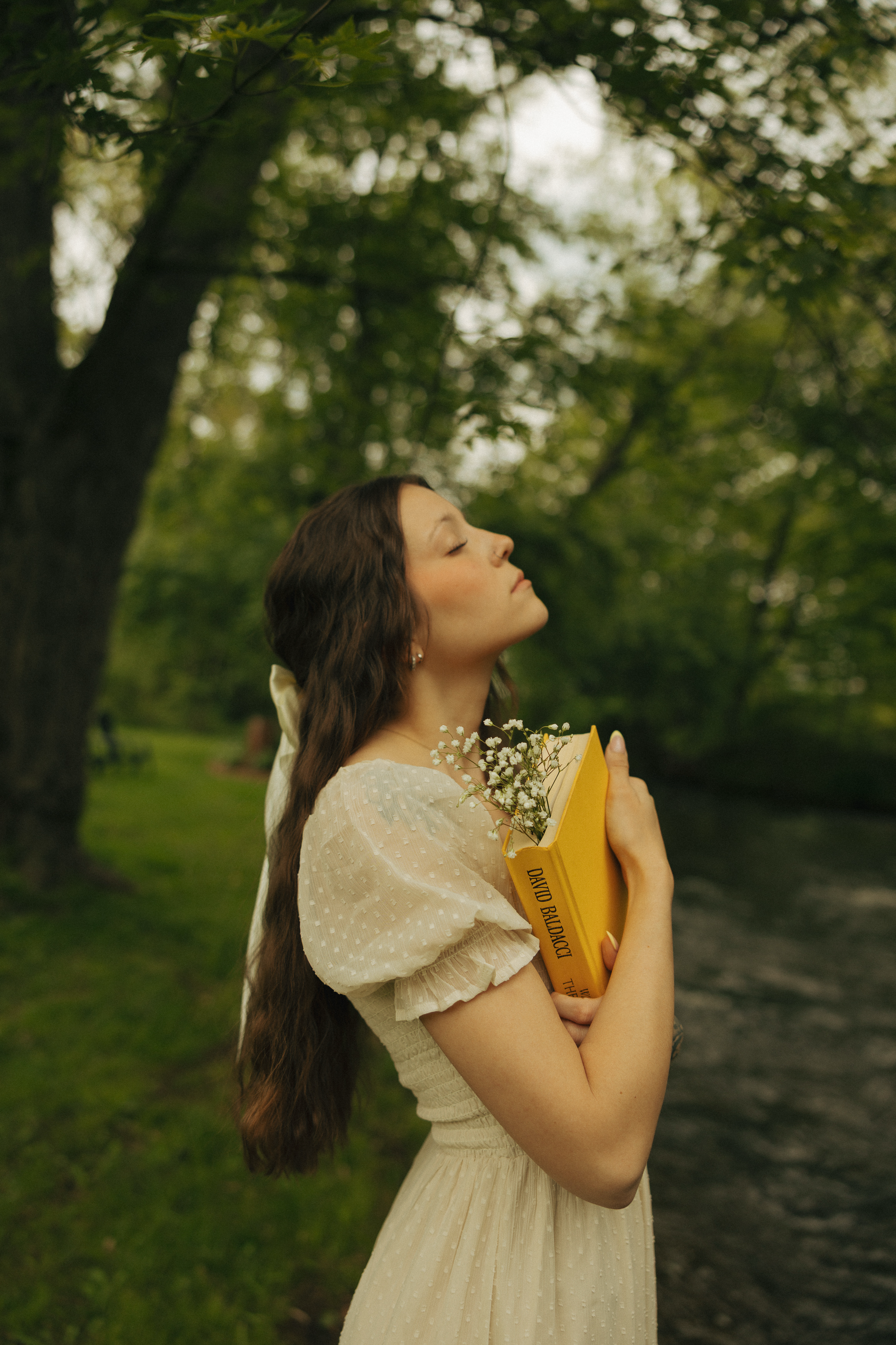 Stand side ways, holding your book, and gently tilt your closed eye face backwards