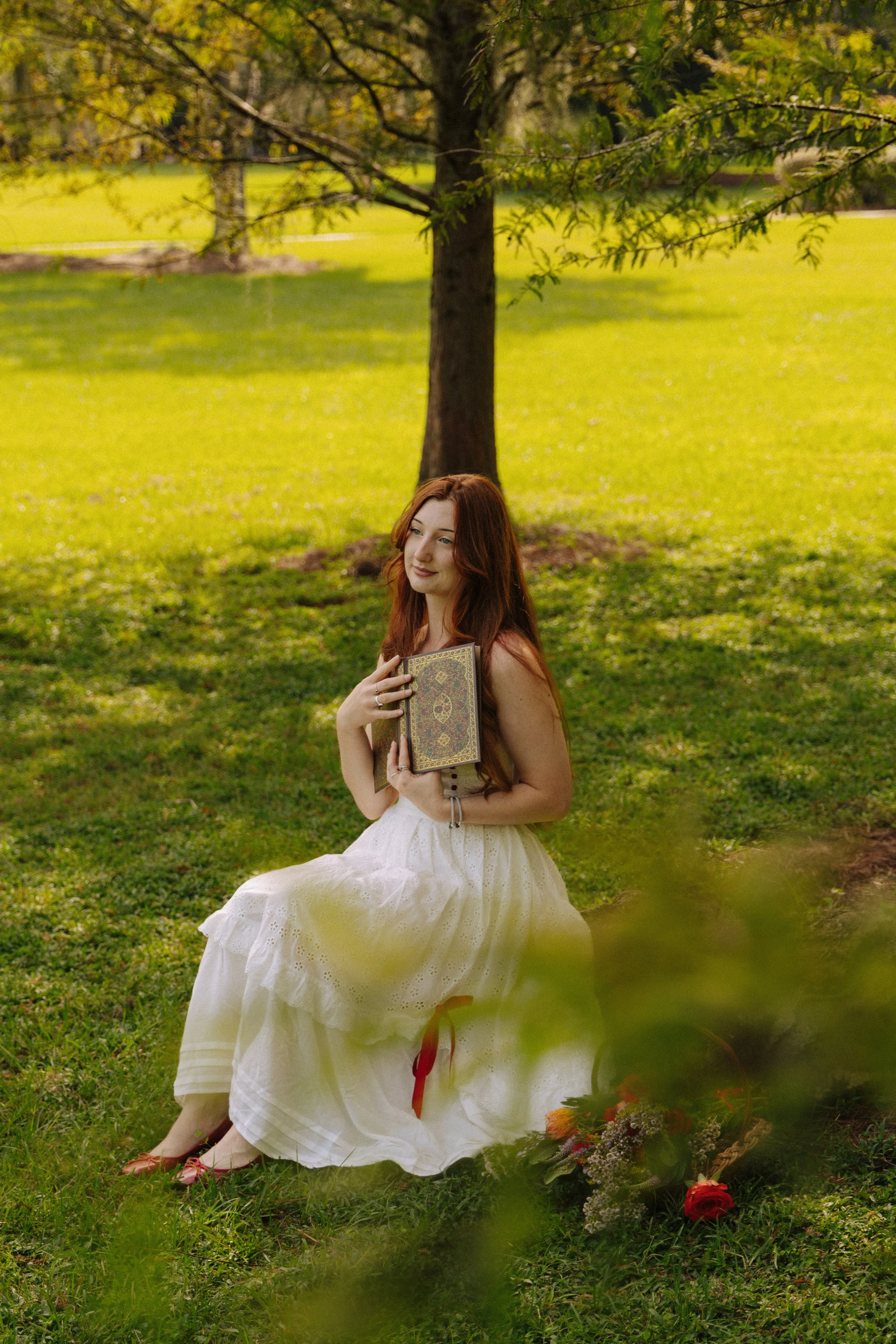 Sit on a low rock and hold a book close to your chest while looking into the distance