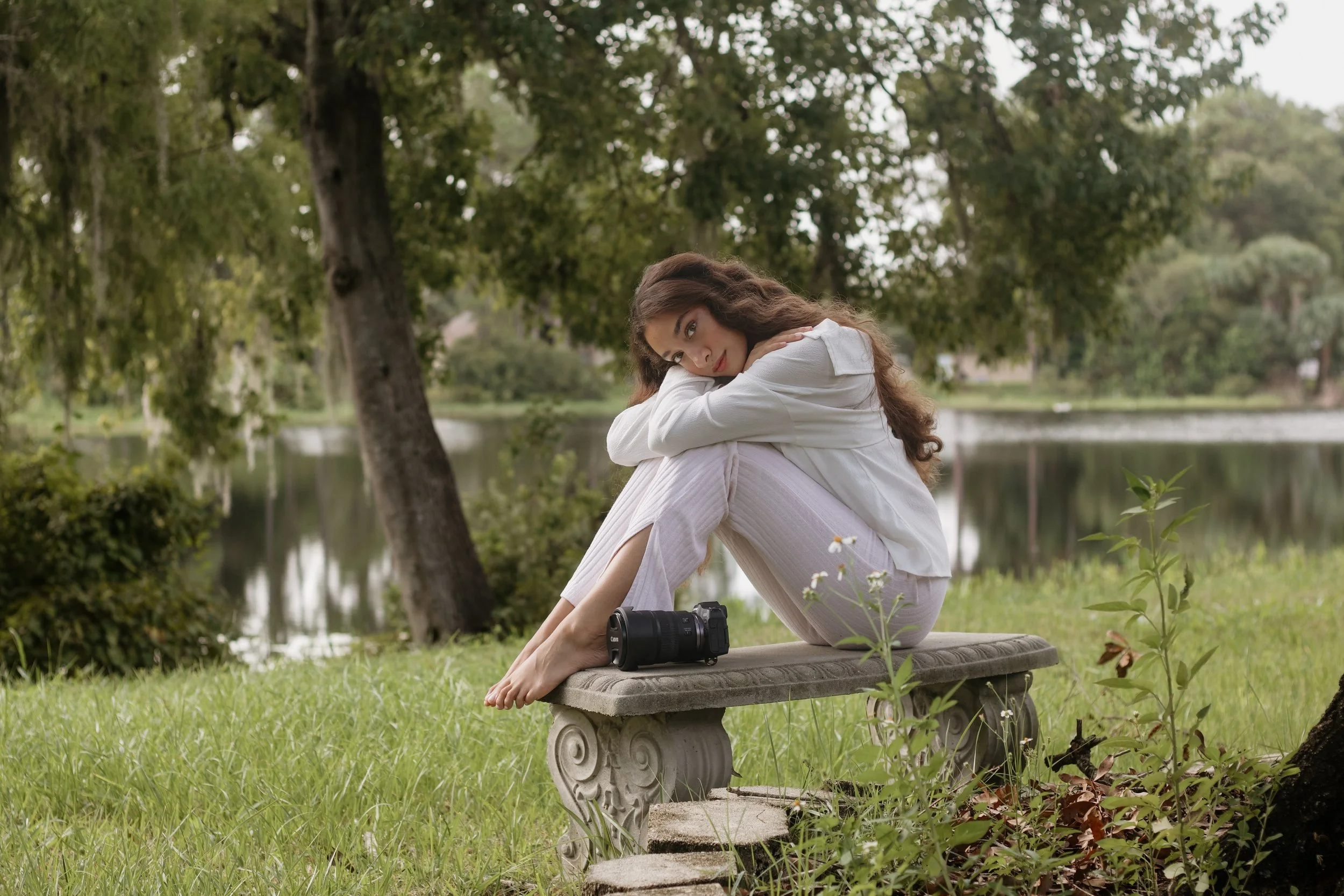 sit on the bench with both of your knees pulled up close to your chest, wrap your arms around your legs