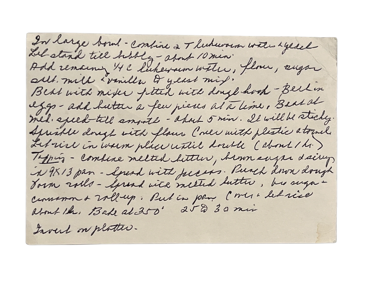 Handwritten recipe on a lined index card for making pecan sticky buns, including ingredients and step-by-step instructions.