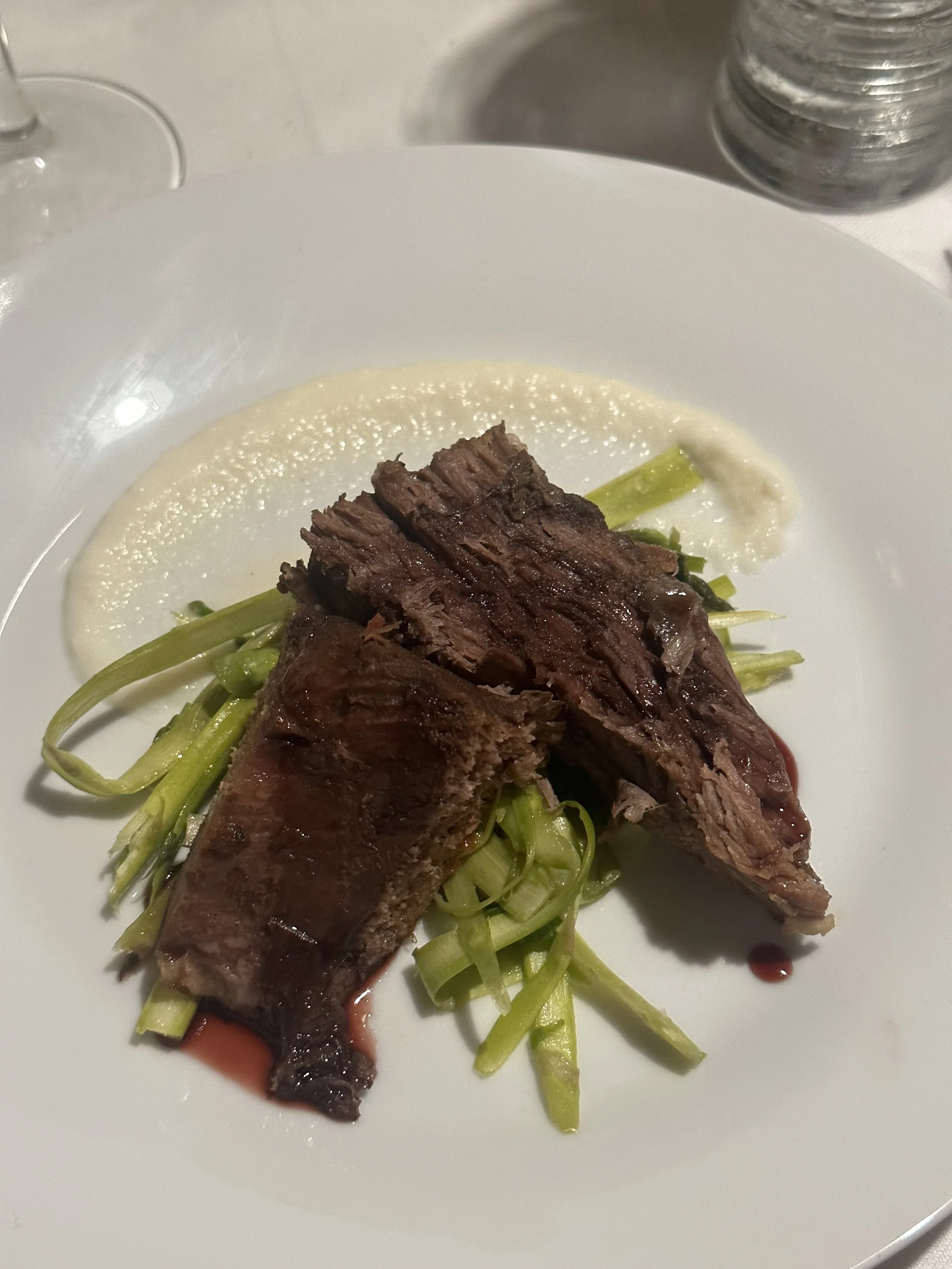 Braised leg of lamb, pomegranate molasses, shaved asparagus mint salad, parsnip puree