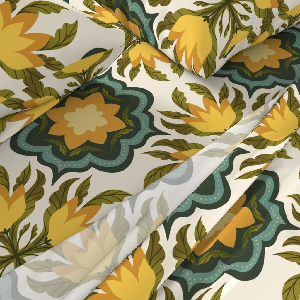 Close-up of fabric with a floral pattern featuring large yellow and orange flowers, green leaves, and blue accents on a white background.