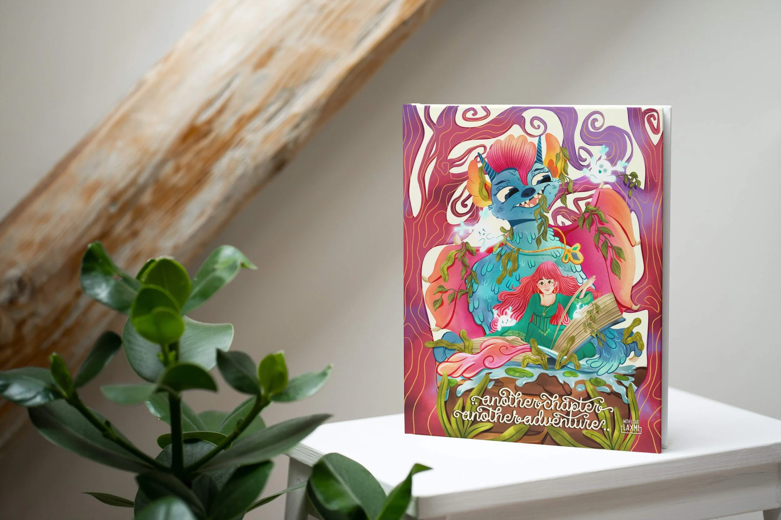 Colorful illustrated book cover titled 'another chapter another adventure' with a blue monster with pink hair and a girl with red hair and a green dress, sitting on an open book surrounded by magical smoke and nature elements.