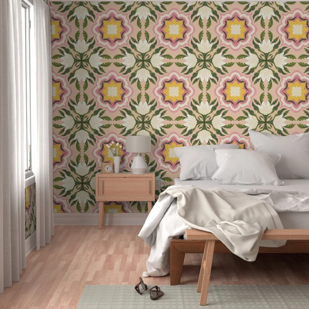 Bedroom with a floral patterned accent wall, unmade bed, nightstand with a lamp, clock, and flower vase, pair of glasses on the floor, and curtains on the window.