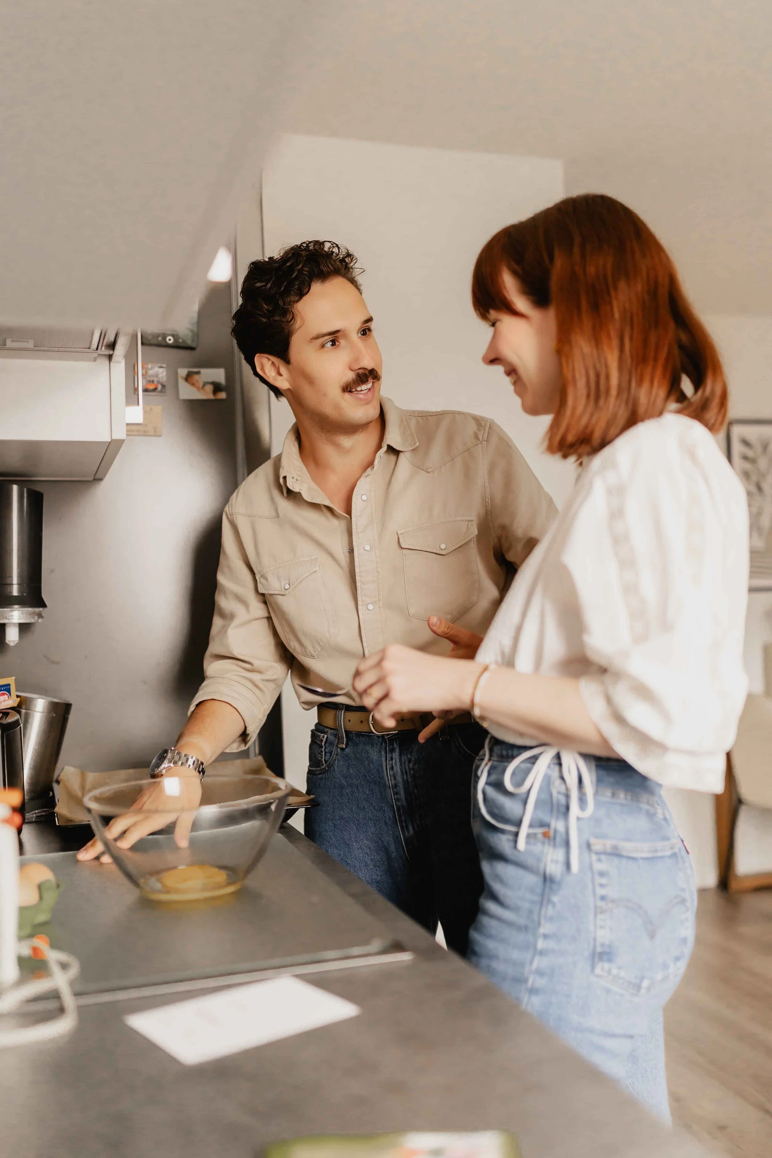 Paar lacht gemeinsam in der Küche während der Homestory beim Kochen in Lüneburg