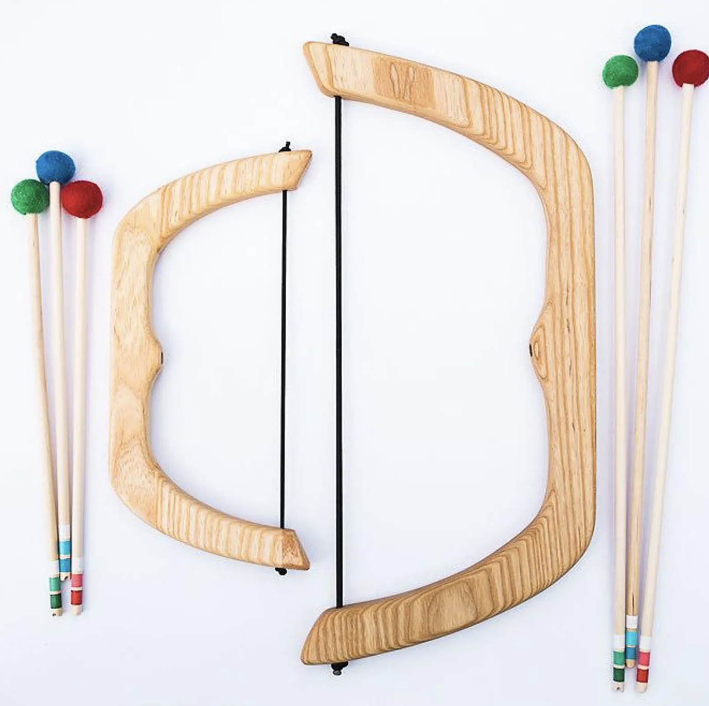 Wooden musical bows with colored mallets displayed on a white background.
