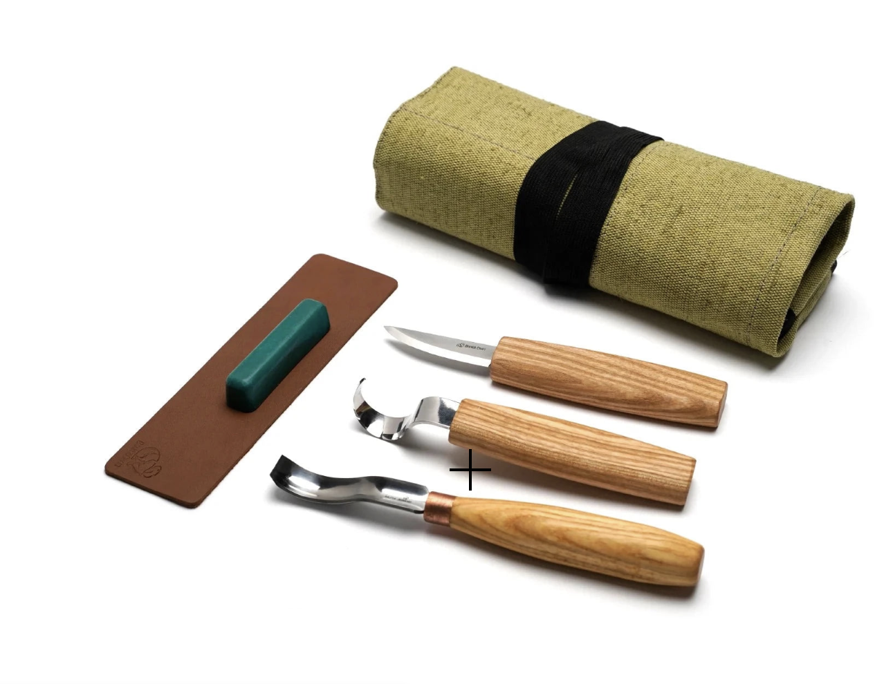 Set of wood carving tools including three knives with wooden handles, a sharpening strop with compound, and a green canvas roll-up case.