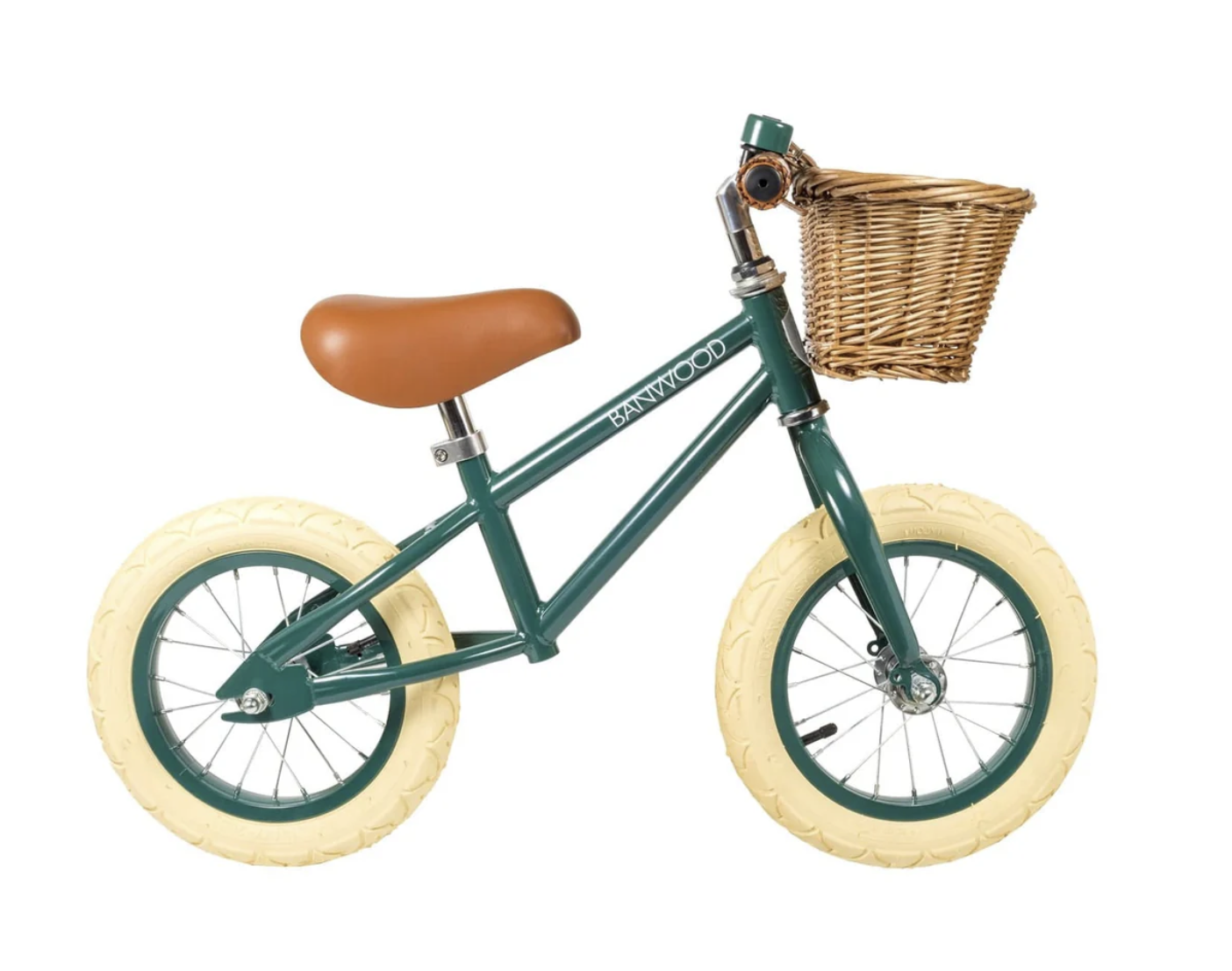 Green balance bike with cream wheels and a brown leather seat, featuring a wicker basket on the handlebars.