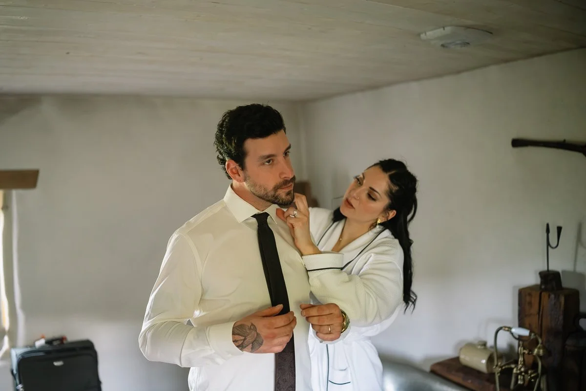 Bride helping groom with his tie before their Ireland elopement