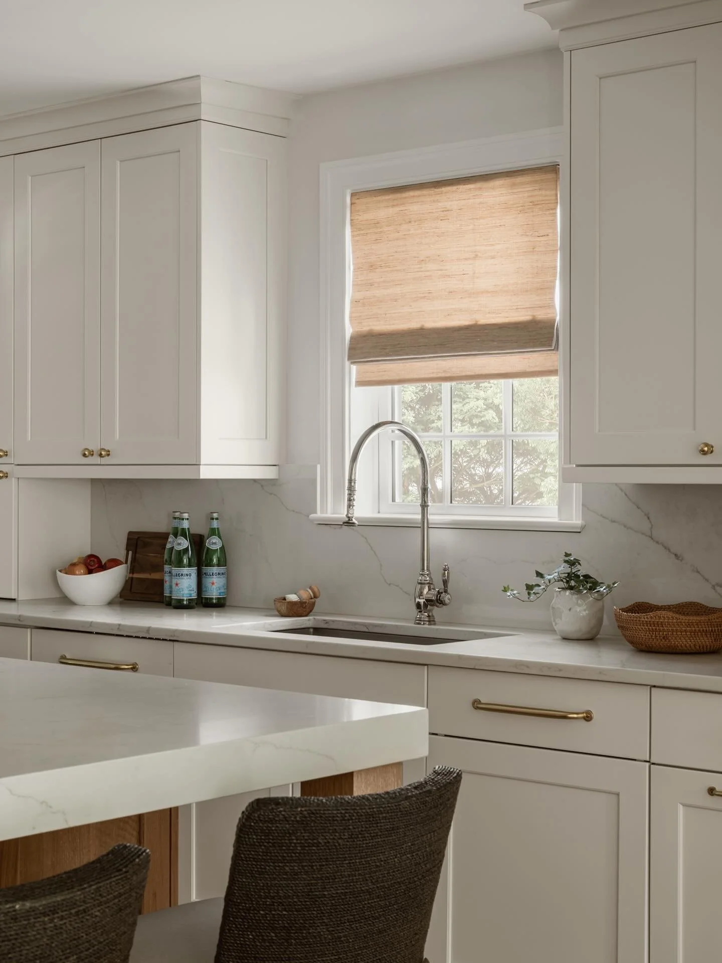 The mix of textures tells the story.
The woven softness of the Roman shade and the natural texture of the stool capture what our design style embodies&mdash;organic spaces that feel lived-in, layered, and intentional. Every detail is chosen to create