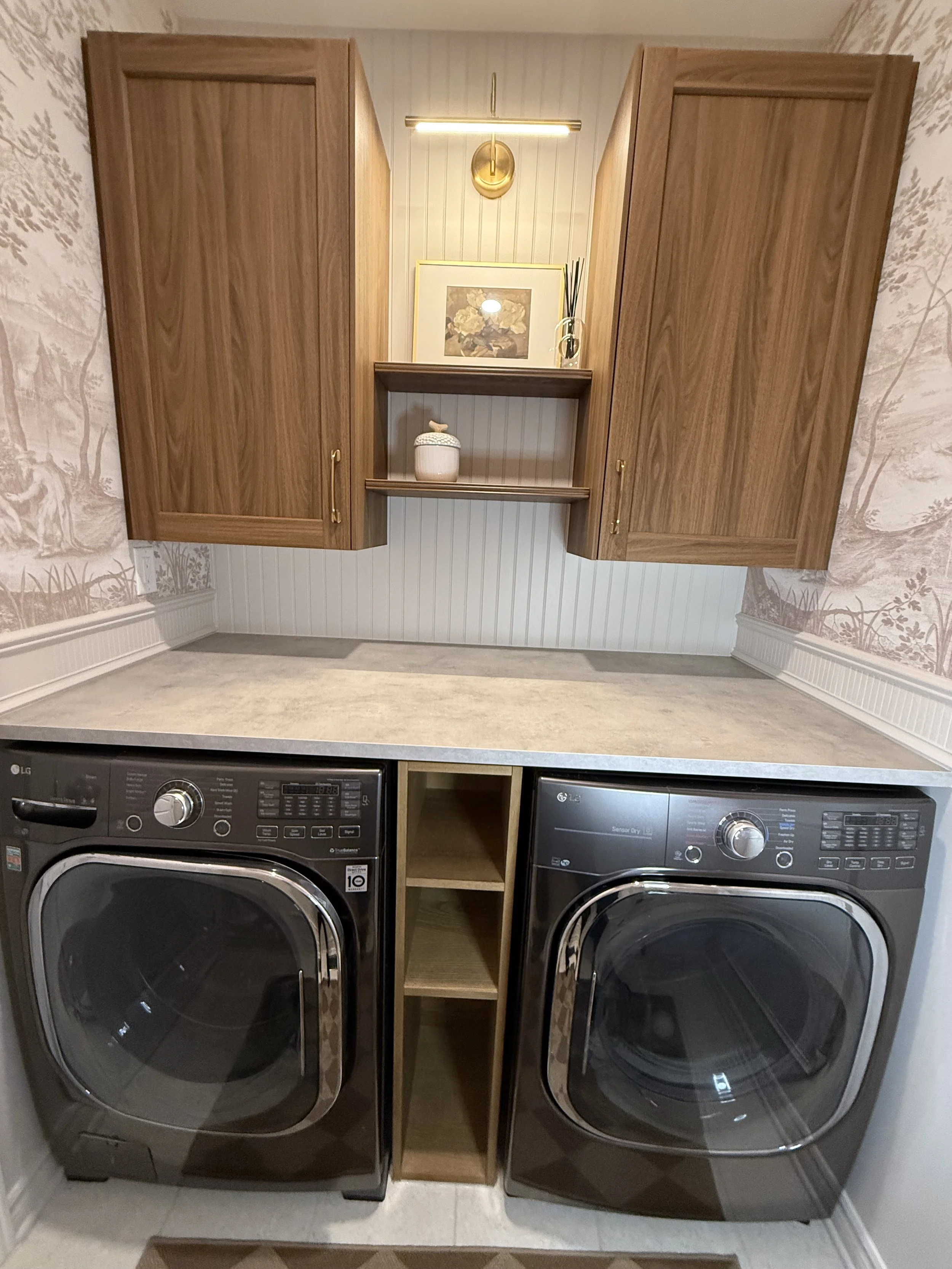 Laubdry room with unedr the counter storage solution, wall cabinets, open shelves and acent lighting. 