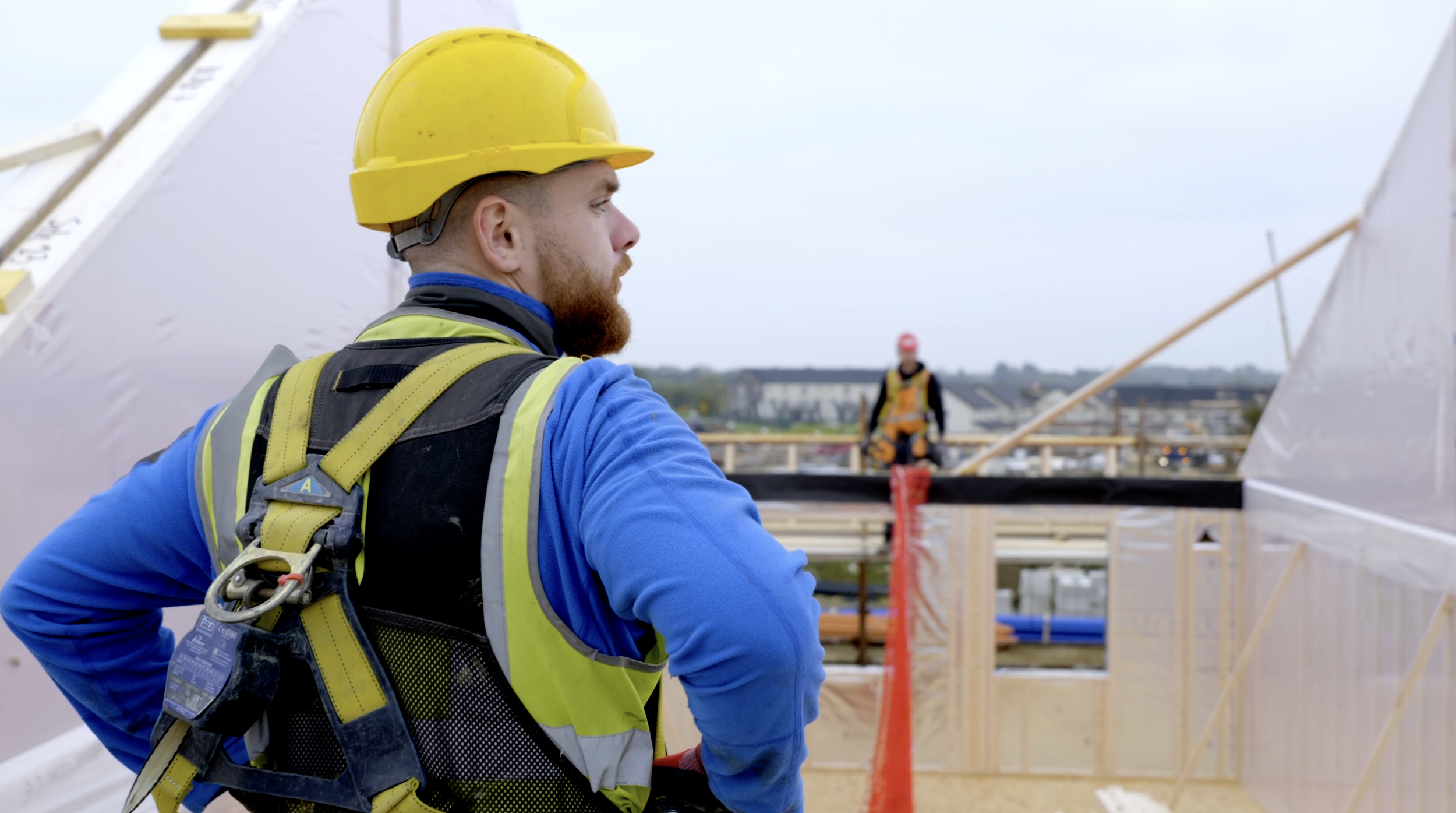 Worker with harness on installing trusses for KTF