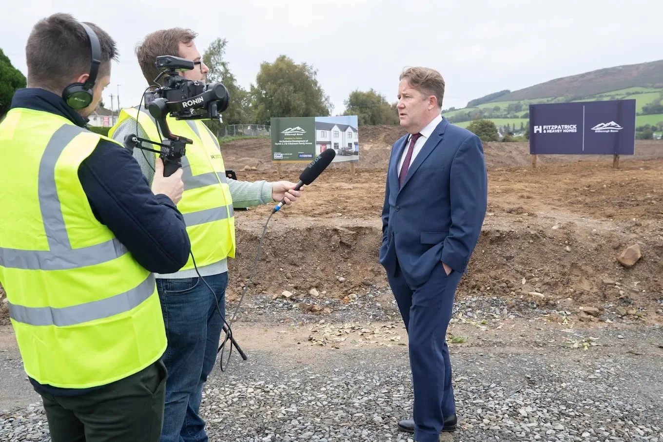 Film crew on construction site interviewing Minister Darragh O'Brien
